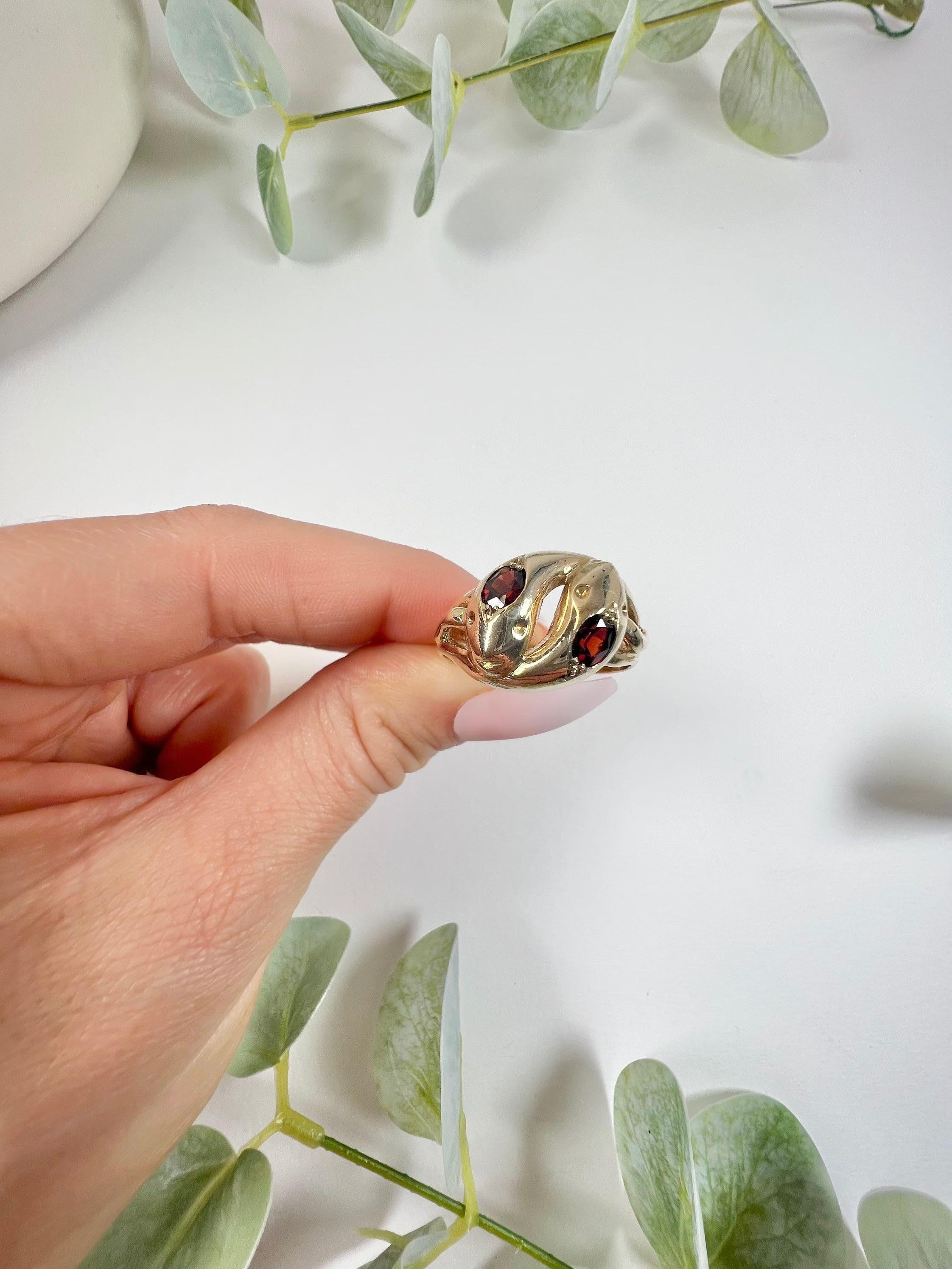 Vintage Snake Ring 

9ct Gold Stamped 

Hallmarked Birmingham 1960

Fabulous, vintage, double headed snake ring. Both heads set with faceted, natural garnets. The yellow gold bodies of the snakes, coil around the finger with the tails exposed in the