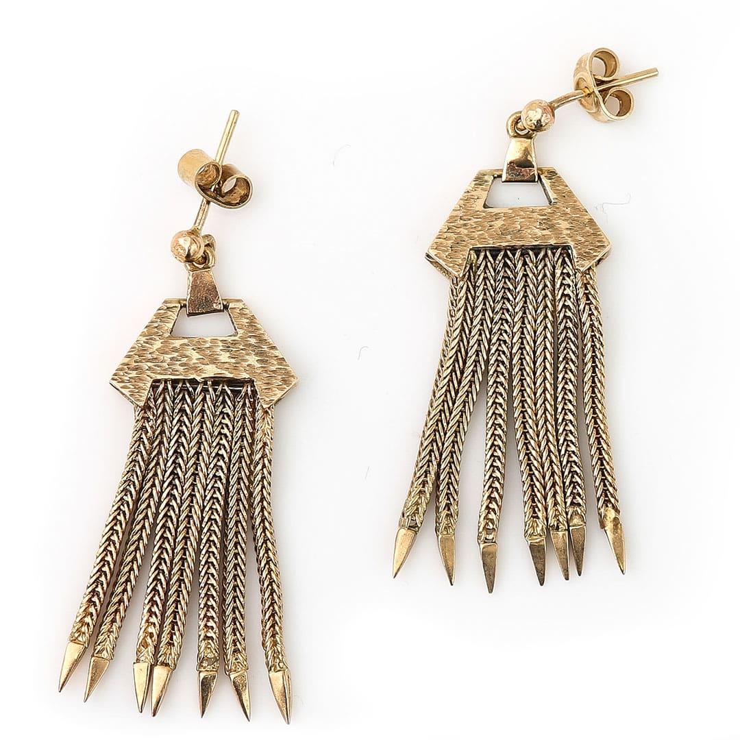 A super stylish pair of vintage 9ct yellow gold foxtail tassel drop earrings dating from circa 1980. The heads of the earrings are designing of a solid, geometric form which has engraved surfaced typical of the period and this style is very