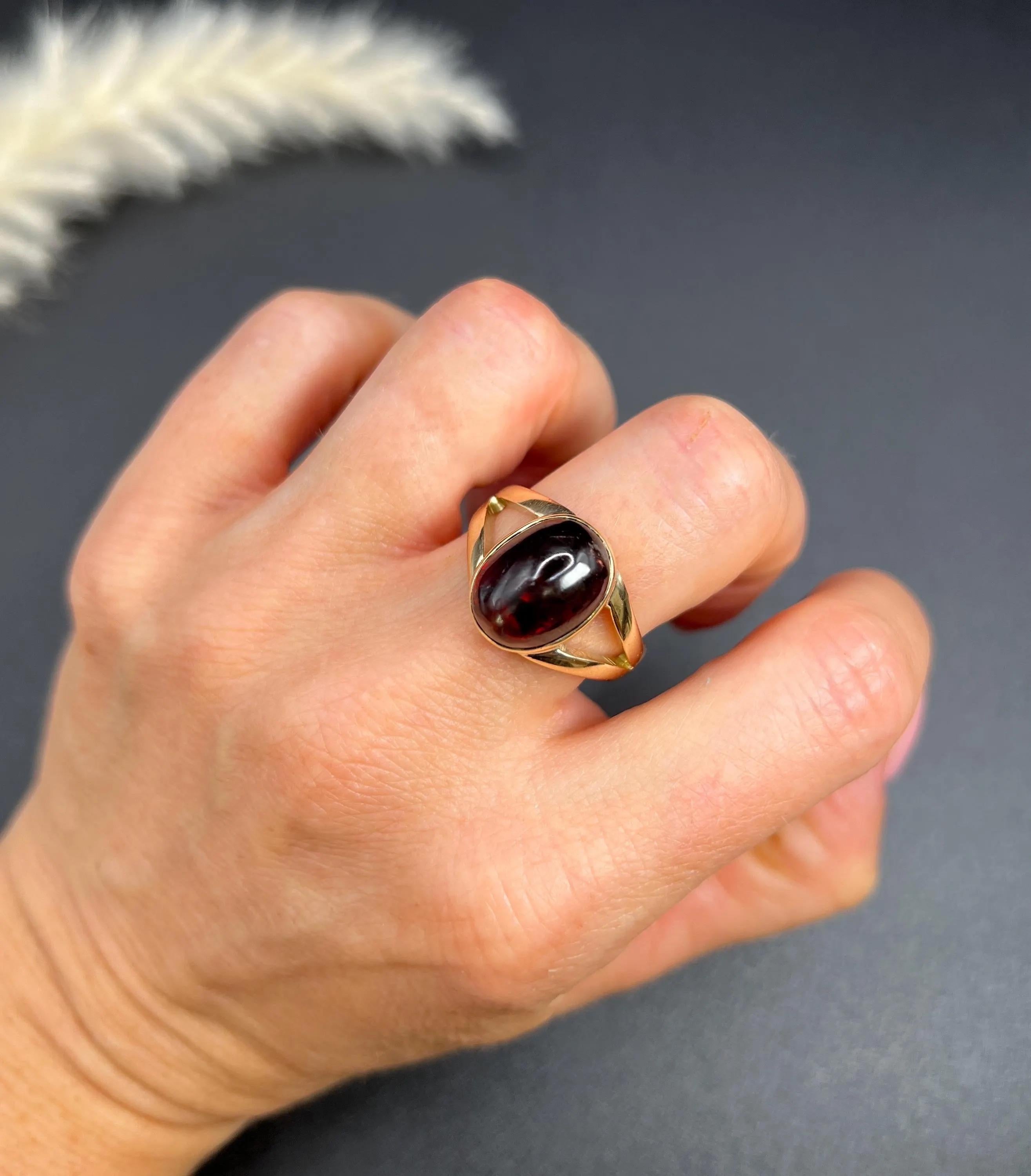 Vintage Signet Ring 

9ct Yellow Gold 

Hallmarked Birmingham 1979

Makers Mark O E C 

This vintage oval-shaped 9ct yellow gold signet ring from the 1970s is a stunning piece of jewellery. It features a beautiful, rich red-coloured cabochon garnet