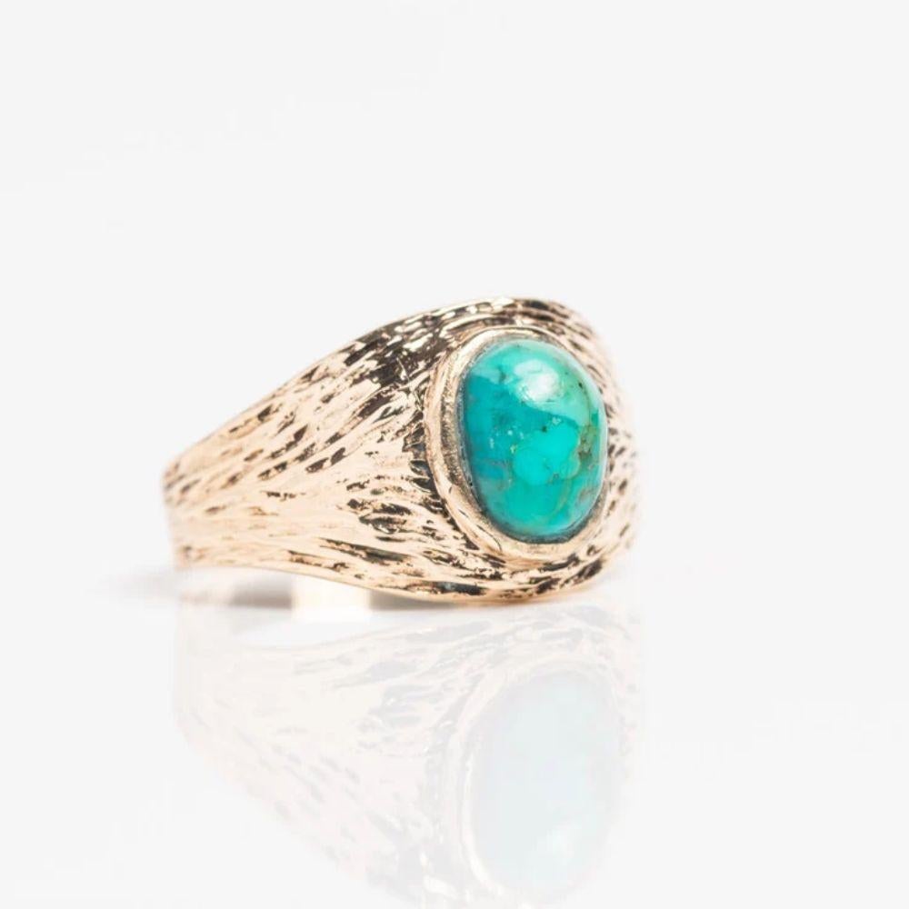 This stunning vintage 9ct gold and turquoise signet ring is made with a rare and beautiful bark design with a central turquoise cabochon. The stone has light and dark blue shadows making this piece even more interesting.  Fully hallmarked inside for