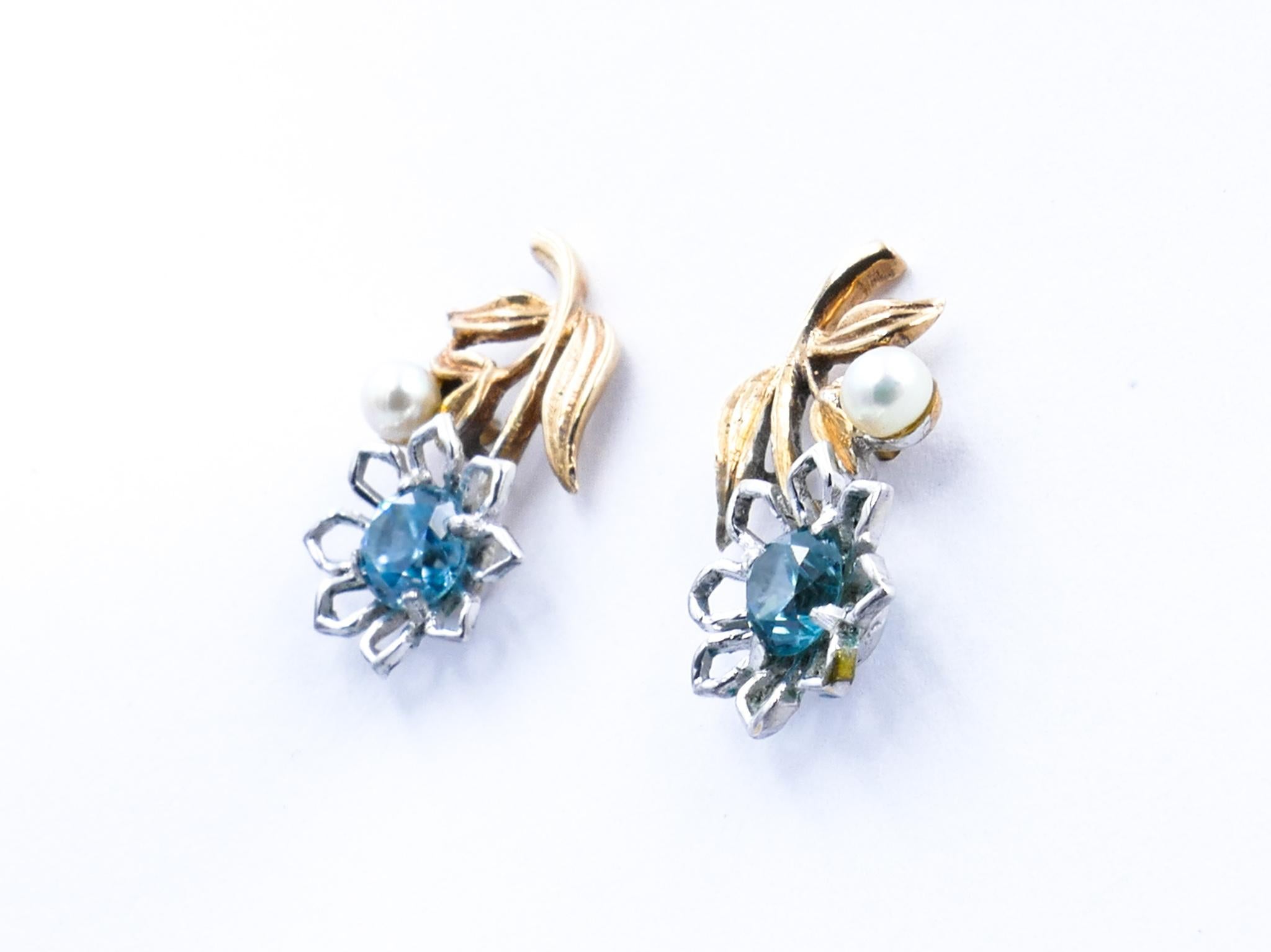 Something just a little bit different!
Vivid, vivid blue Aquamarines are the attraction in these gorgeously feminine 'Flower style' Vintage Earrings, embellished with one creamy/white Seed Pearl each with very good lustre.                           