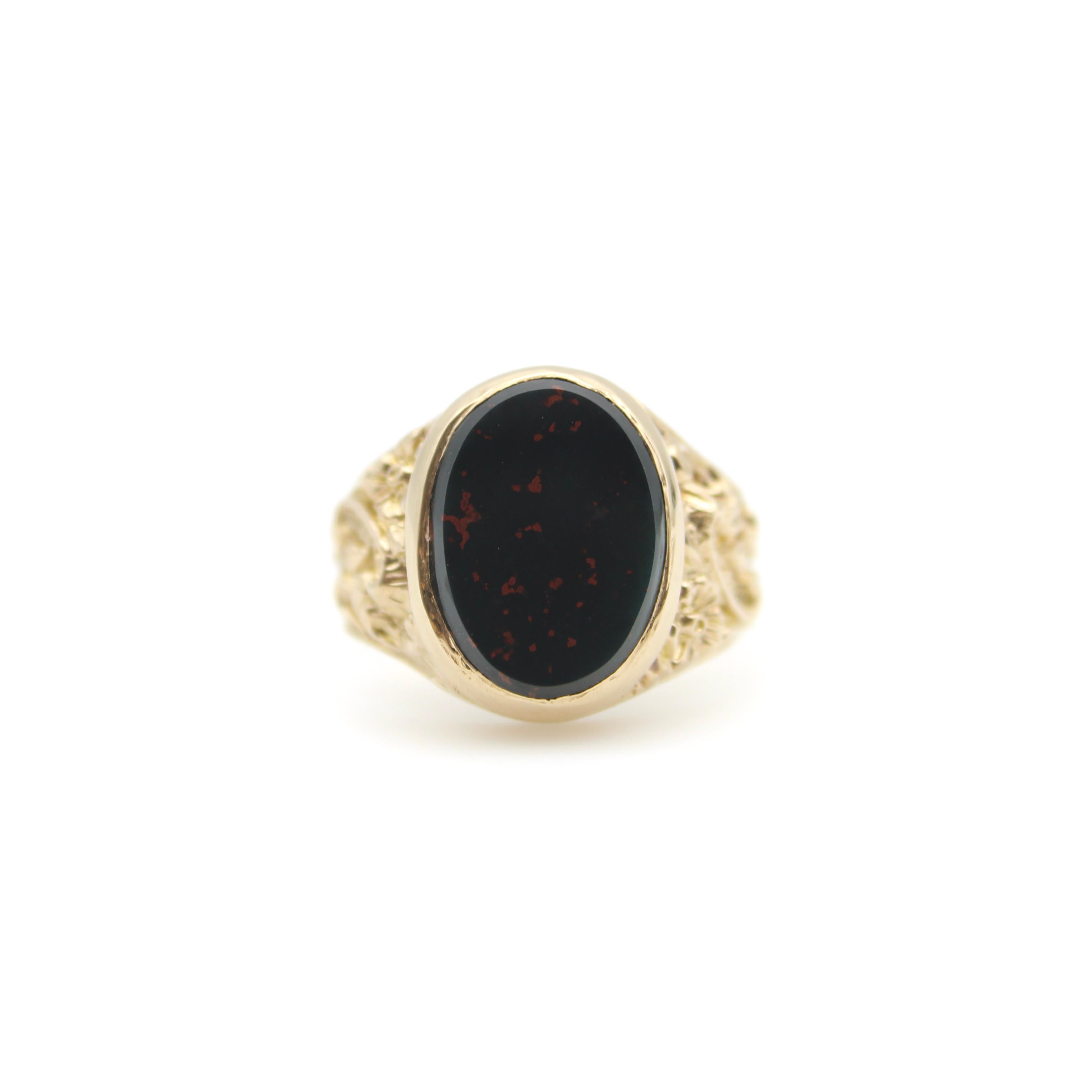 An impressive vintage 9k gold and bloodstone signet ring, done in the style of the Victorian era. The ring features beautiful scrolling foliate details on the band, with an oval red-flecked bloodstone as its centerpiece. 

Bloodstone has been