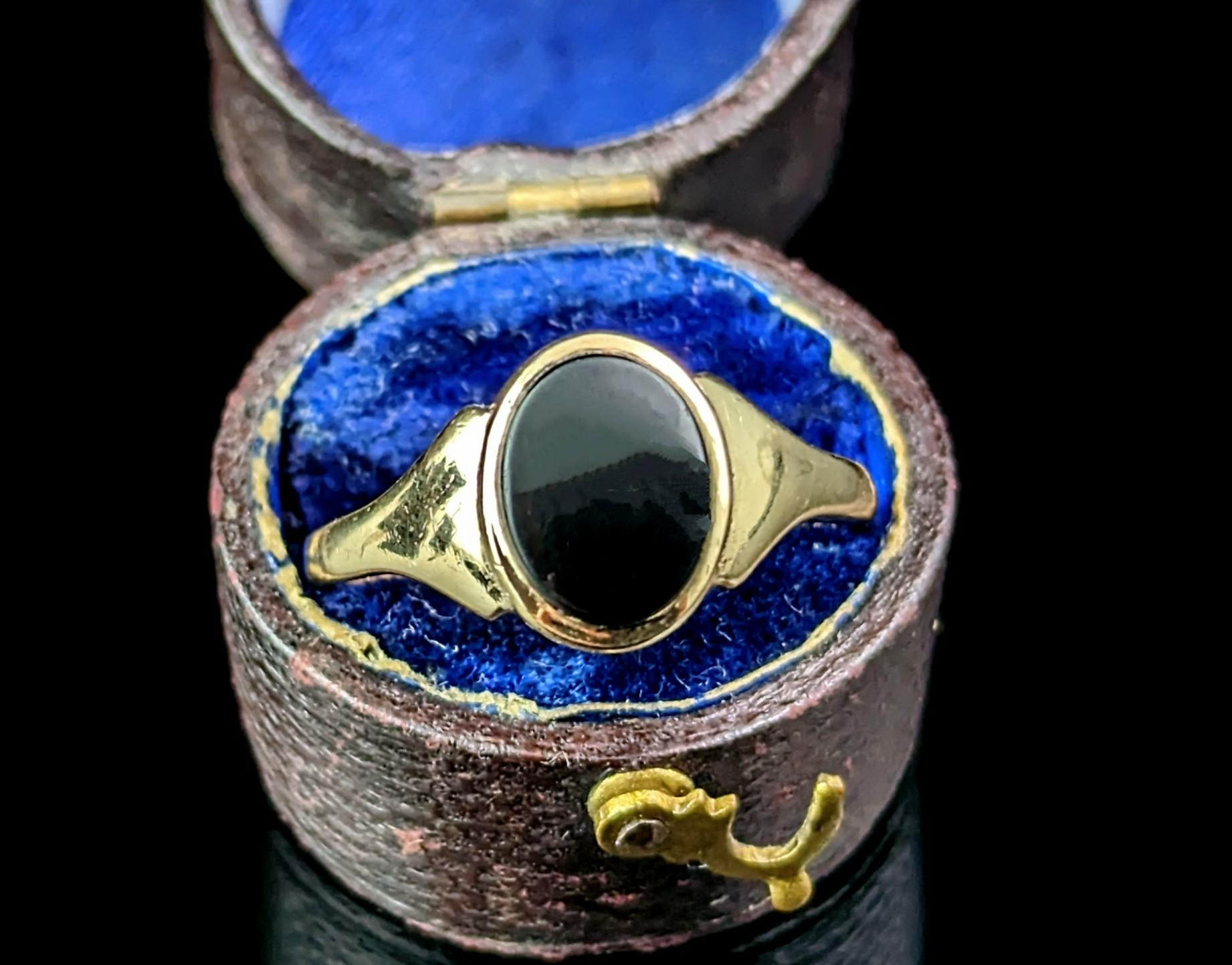 This stylish vintage 9ct gold and Black onyx signet ring is the perfect pinky ring choice!

It has an oval shaped face set with a rich inky black onyx stone, this has not been carved so the stone could be personalised if desired with your initials