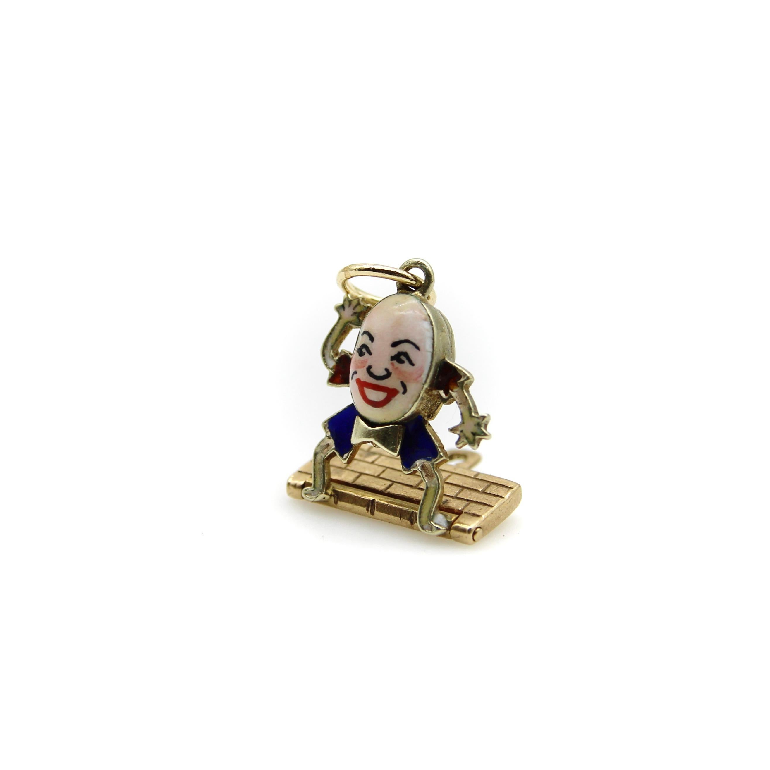 This painted enamel Humpty Dumpty sits on a 9k gold wall, smiling and waving before his great fall! 

The details of this charm are adorable. The enamel on Humpty’s face is hand-painted, and he has a mischievous smiling expression. The red and blue