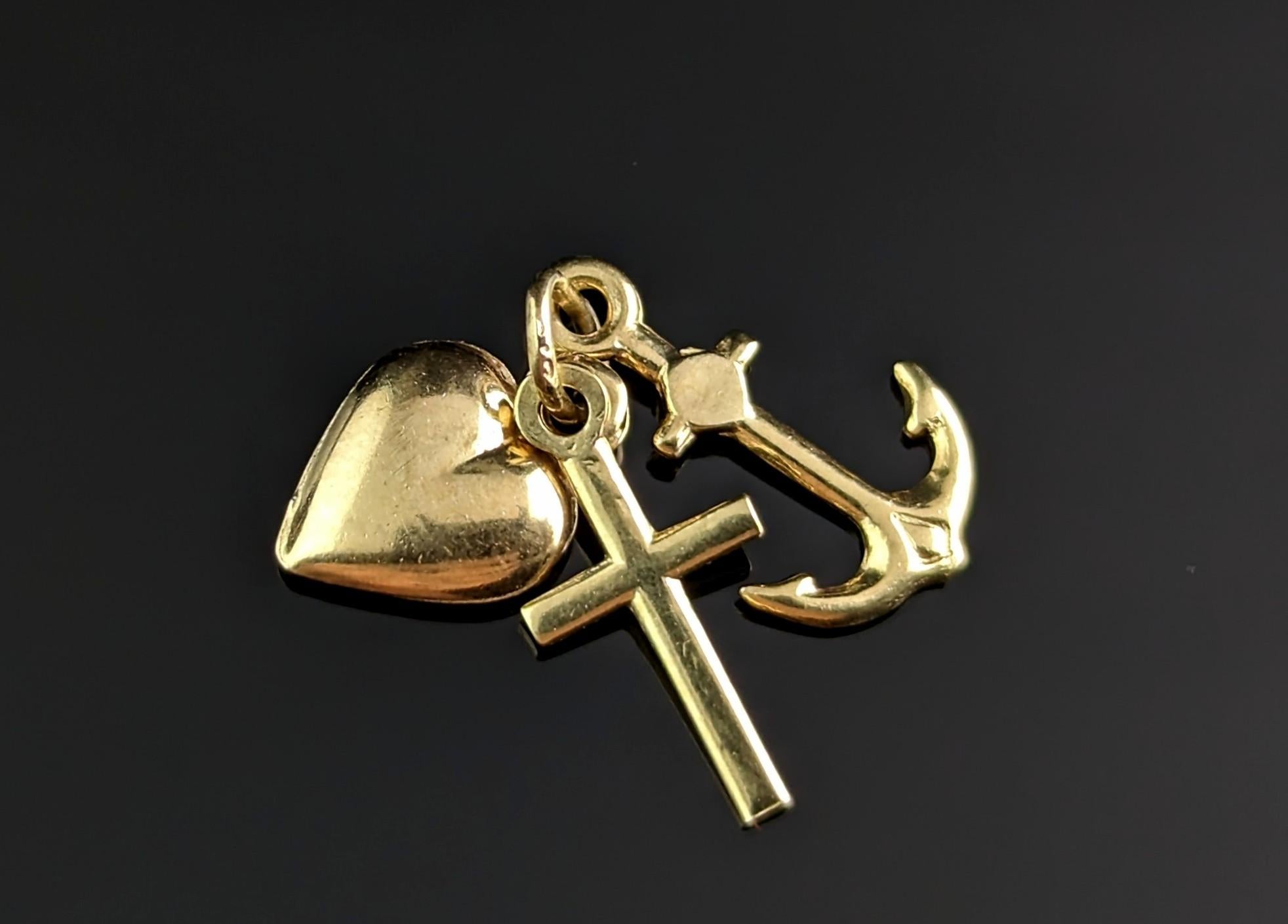 A sweet vintage 9ct yellow gold Faith, Hope and Charity charm.

Rich 9ct yellow gold it features a tiny heart, a cross and an anchor, each symbol representing faith - cross, hope - anchor, charity - heart.

These three tiny charms are held together