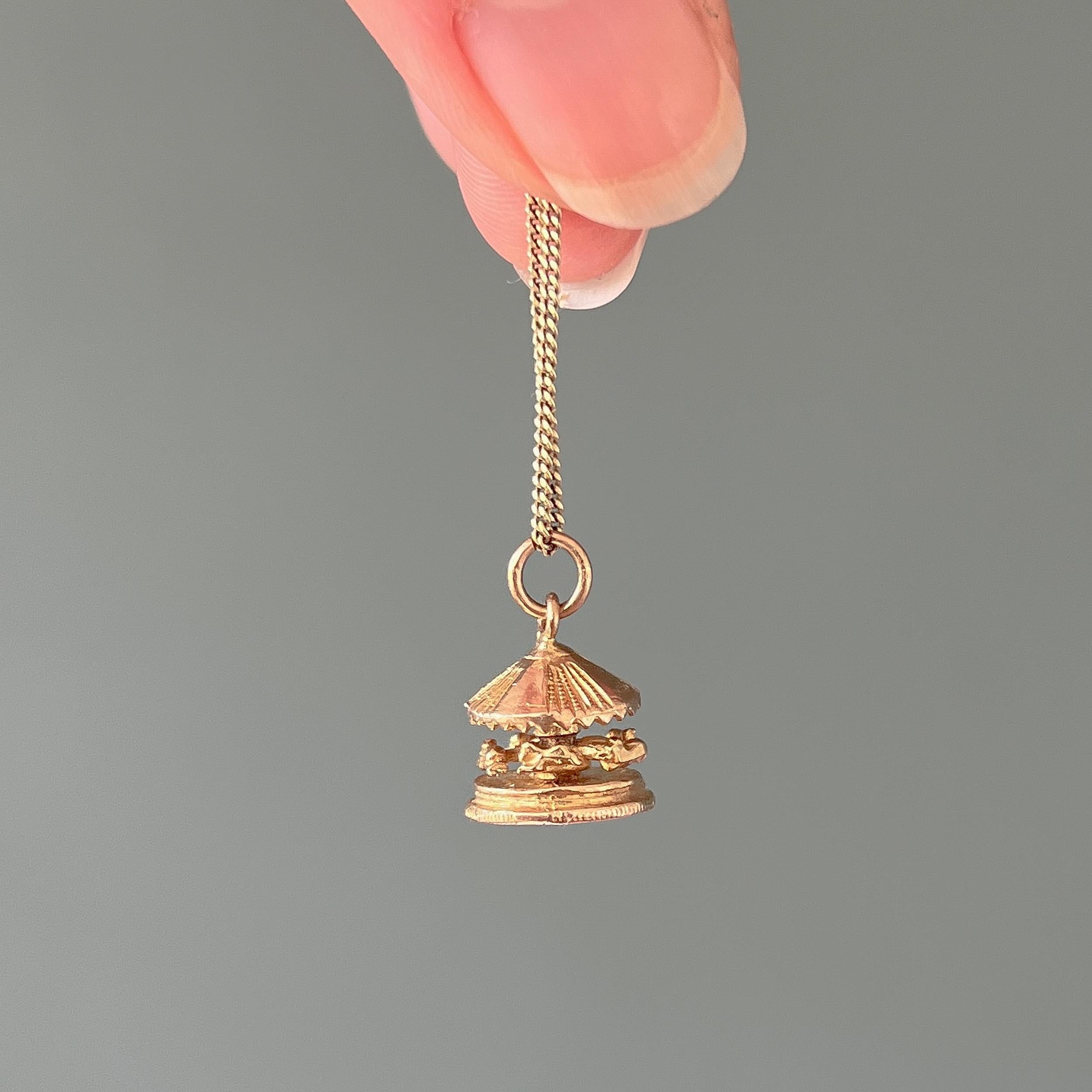 This is a vintage 9 karat yellow gold spinning horse carousel charm pendant. This vintage carousel is detailed with five horses that spin around the pole. The roof and floor of the carousel have some beautiful fluted carvings.

Collect your own