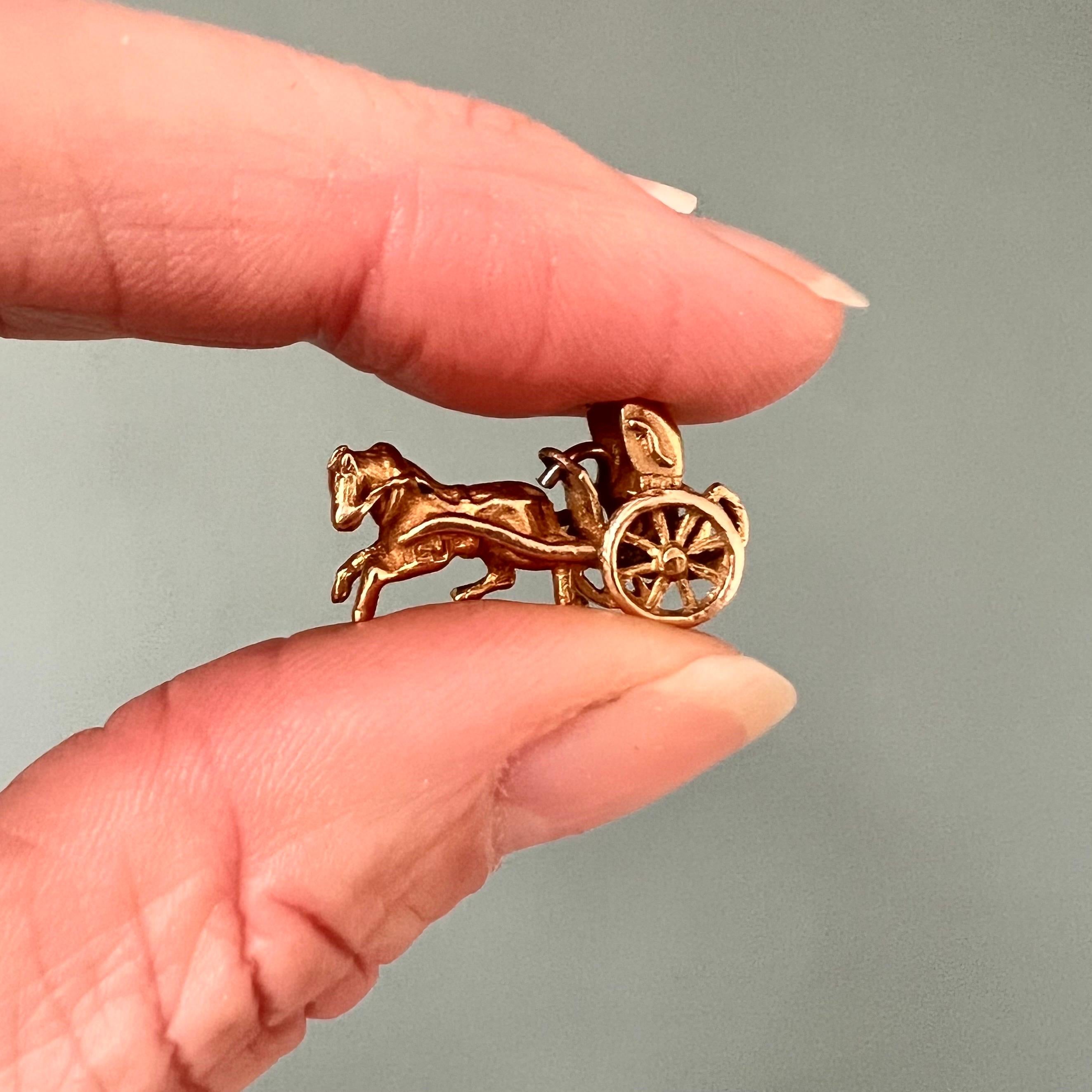 This is a vintage 9 karat yellow gold horse and carriage charm pendant. The carriage is beautifully made with a harnessed horse pulling the carriage. This horse carriage is nicely detailed.

Collect your own charms as wearable memories, it has a