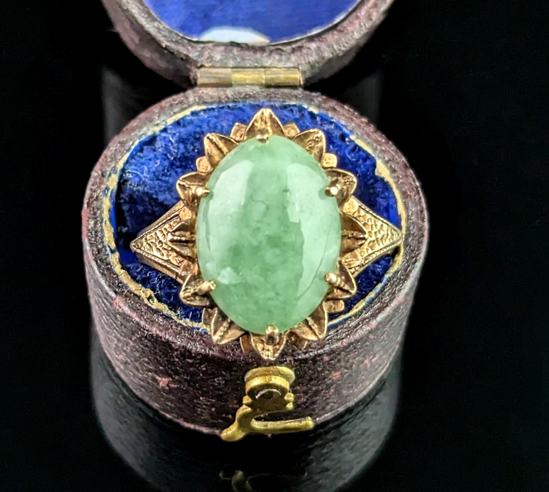 A gorgeous vintage 9ct gold Jade cabochon ring.

A beautiful mottled apple green jade with minty tones claw set into rich 9ct yellow gold.

It has a decorative almost petal like setting and textured shoulders, nature and abstract concepts were both
