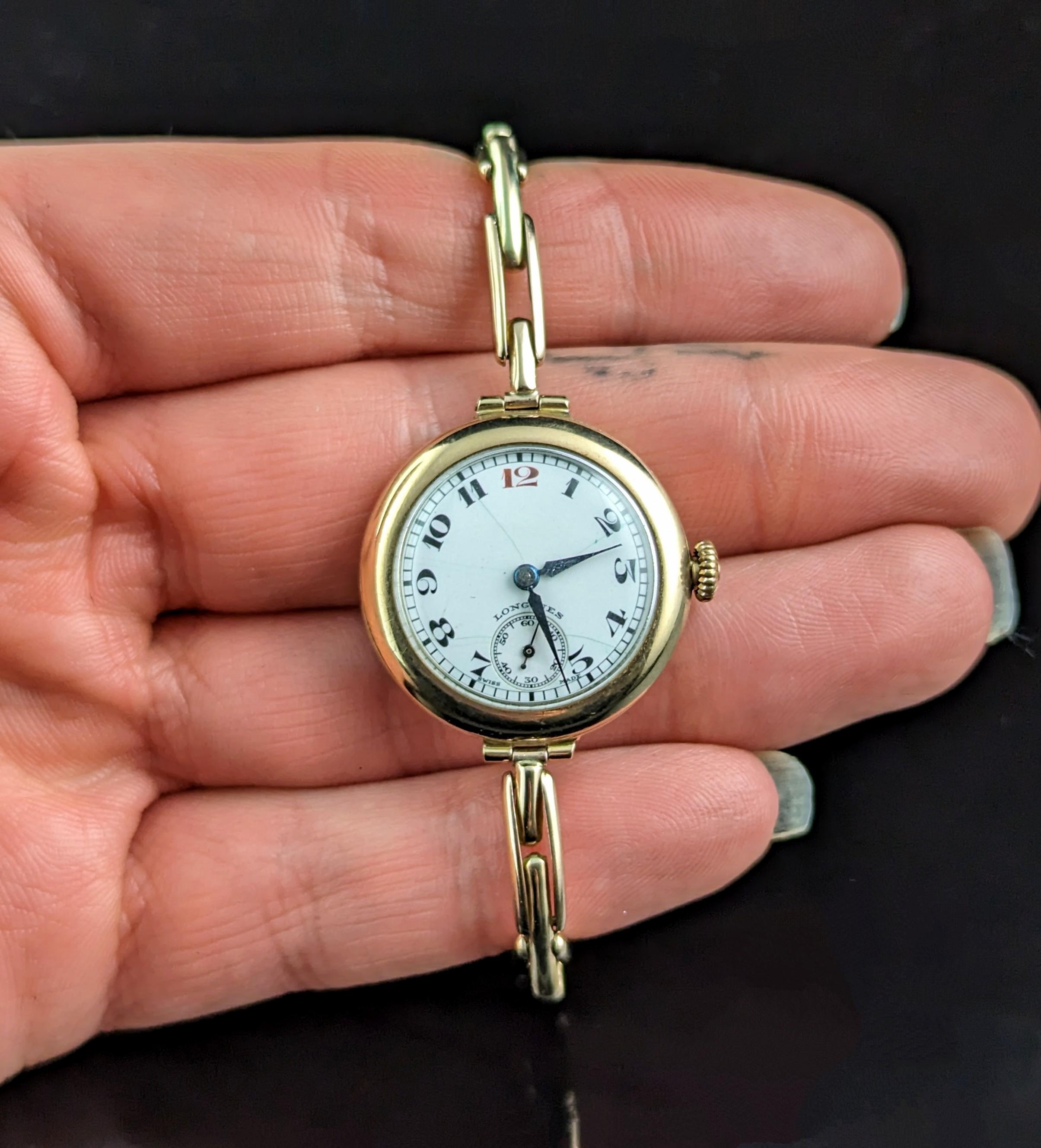 A gorgeous vintage 9ct gold ladies wristwatch.

It has a yellow gold case with a white dial with black Arabic numerals, blued steel hands and a subsidiary second dial, branded just above the seconds dial.

Made by the renowned Longines the dial and