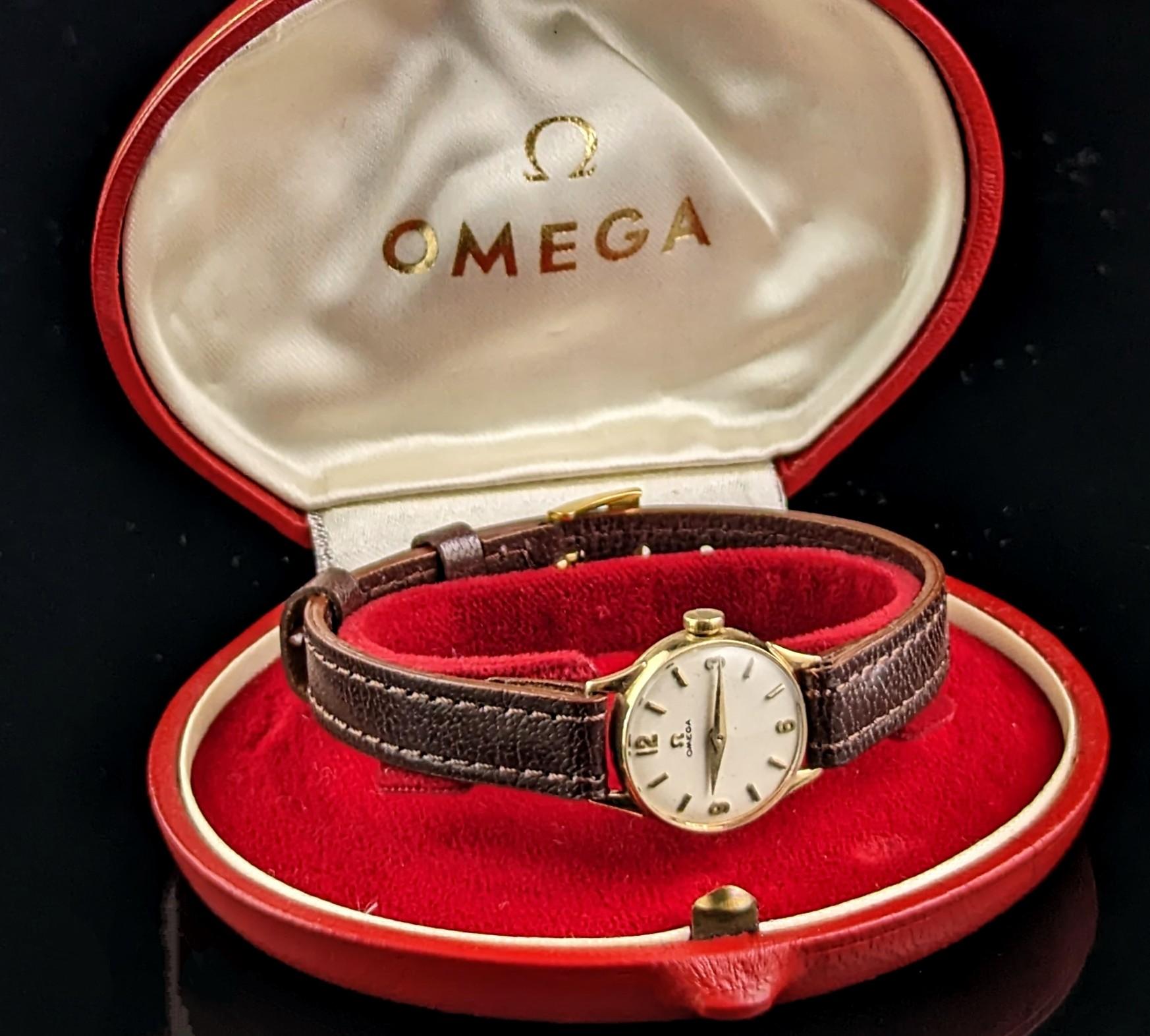 A gorgeous vintage 9ct gold ladies Omega wristwatch.

It has a 9ct yellow gold case, circular in shape with an off white tone dial with gold Arabic numerals and hands and a lightly domed crystal.

Made by the renowned Omega the dial is marked Omega