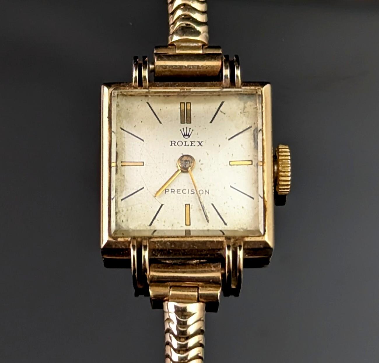 The perfect classic timepiece is what you wil find with this vintage ladies 9ct gold Rolex precision wristwatch.

It features a attractive square shaped case in 9ct gold marked on the outer case and internally hallmarked, the watch has a champagne