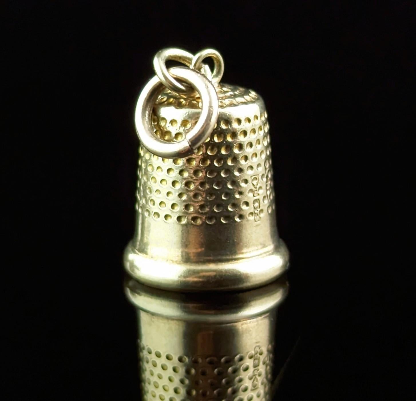This little novelty vintage 9ct gold charm is the perfect gift for the lover of sewing or needle craft.

It is finely modelled in rich 9ct yellow gold as a little thimble, very nicely detailed.

The charm is a mid-century piece and is hallmarked to