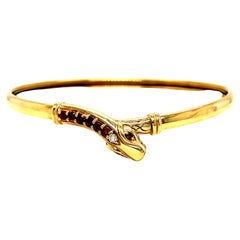 Bracciale a serpente in oro 9K vintage con rubini e diamanti.