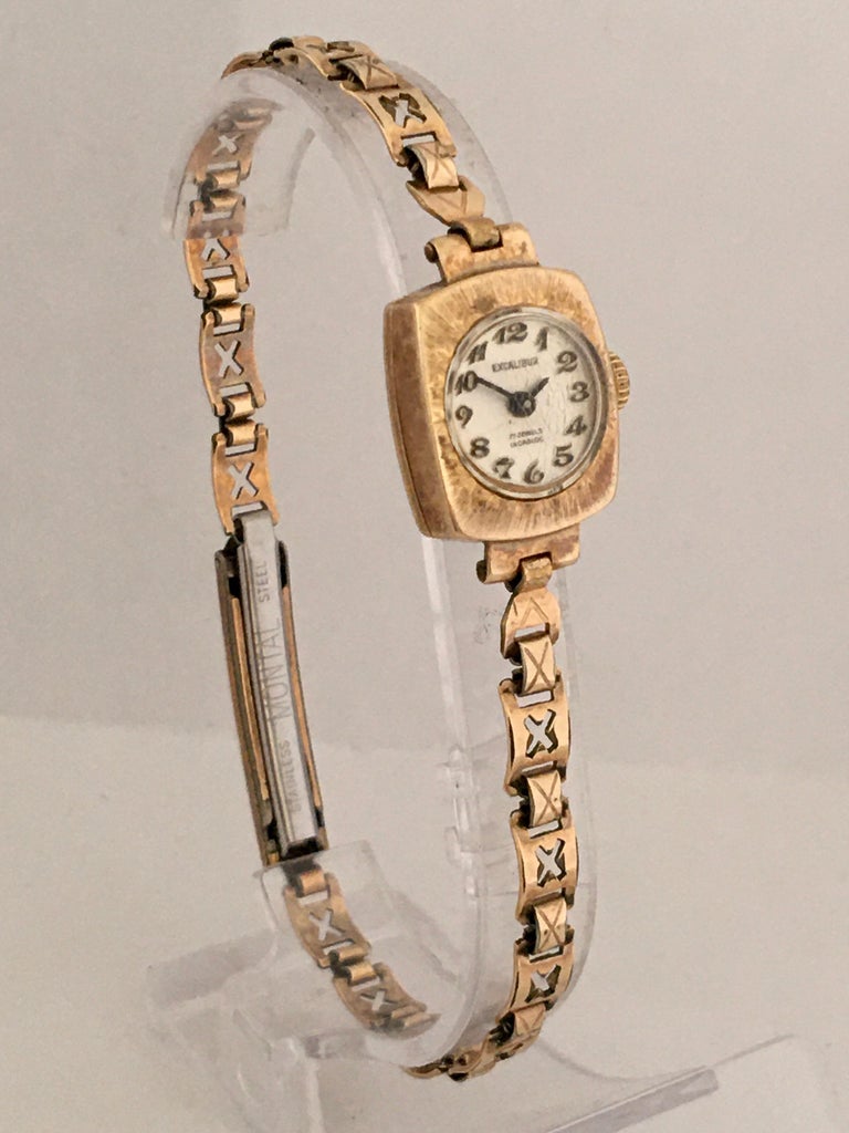 This beautiful little gold watch is working and ticking well. Visible signs of aged and wearing, some tiny scratches on the glass and it’s gold case & band. The gold plated & Stainless watch buckle is a bit tarnished as shown. 

Please study the