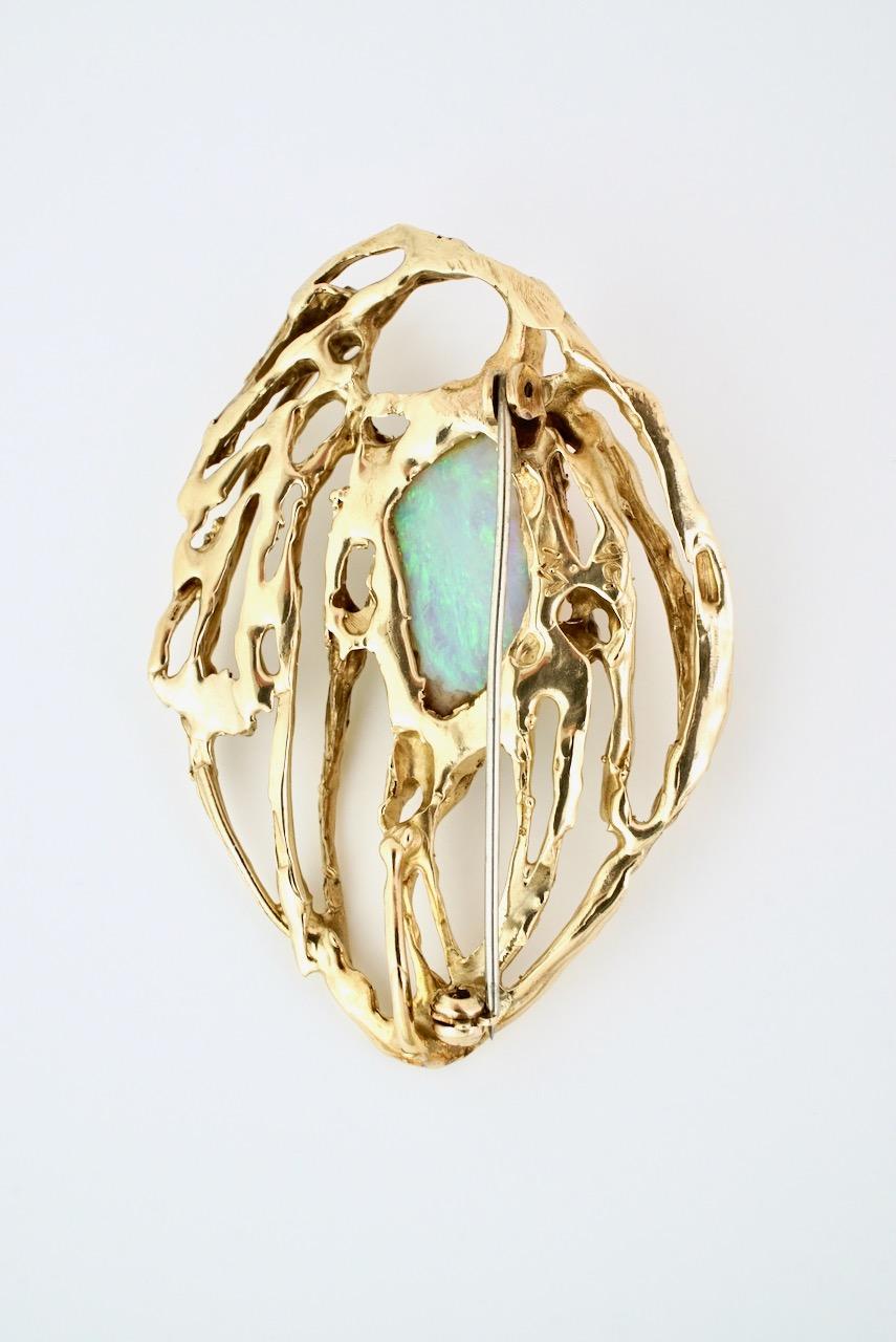 A vintage 9k yellow gold abstract Andamooka crystal opal brooch - a freeform Andamooka crystal opal claw set in an abstract openwork leaf design with a rollover clasp to the pin at the back - this wonderful freeform design while bold in scale is
