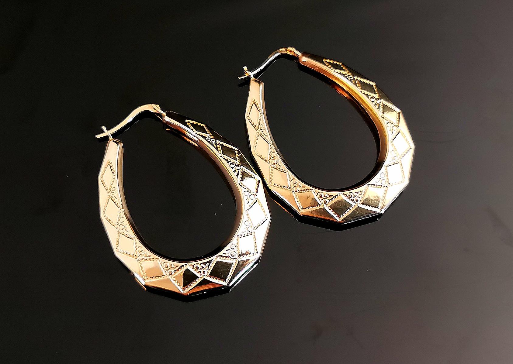 A gorgeous pair of vintage 90s large 9kt gold hoop earrings.

These are crafted in yellow gold with diagonal yellow gold engraving in a creole shape.

Large sized hoops with a beautiful design and a lightly engraved finish, a very well designed pair