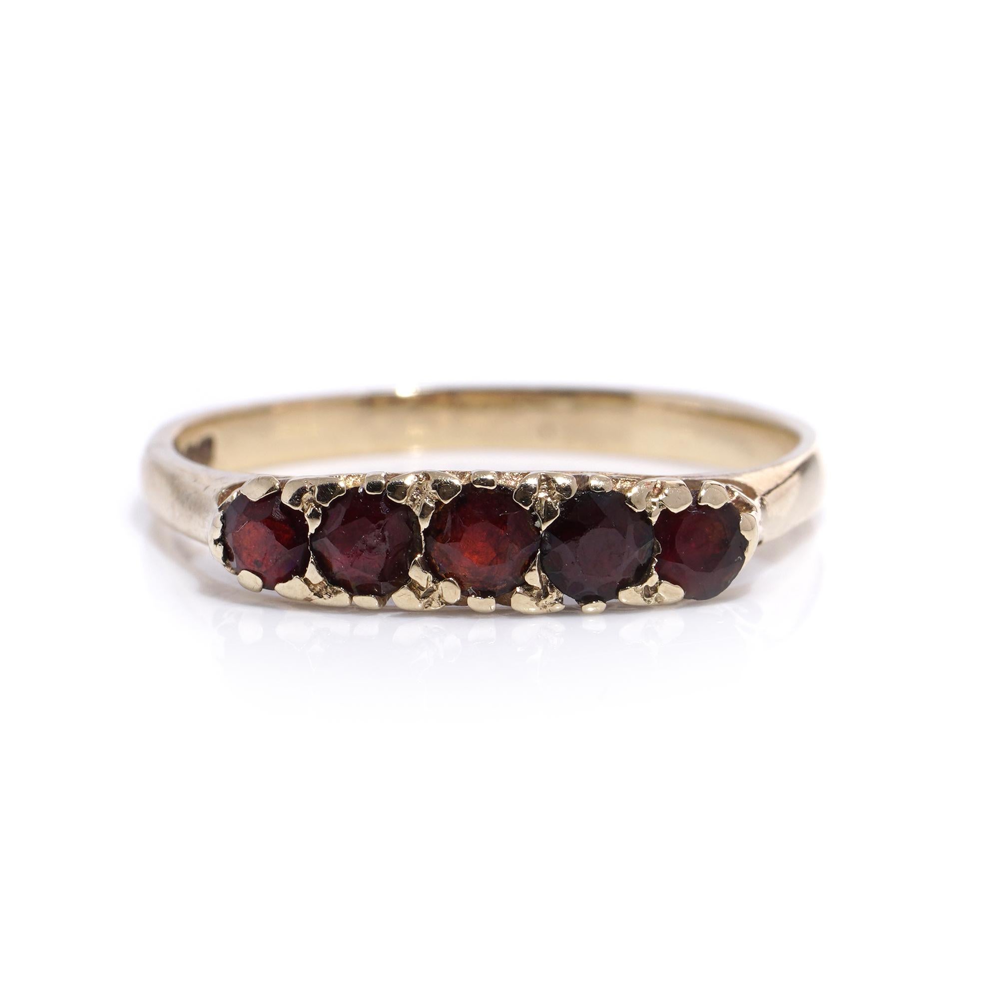Vintage 9kt yellow gold five-stone garnet ring.
Made in England, London, 1982
Fully Hallmarked.

Dimensions -
Finger Size (UK) = L (EU) = 53 (US) = 6
Weight: 2.00 grams

Garnets -
Cut: Round faceted
Quantity of stones: 5
Carat weight: 0.41 carats in