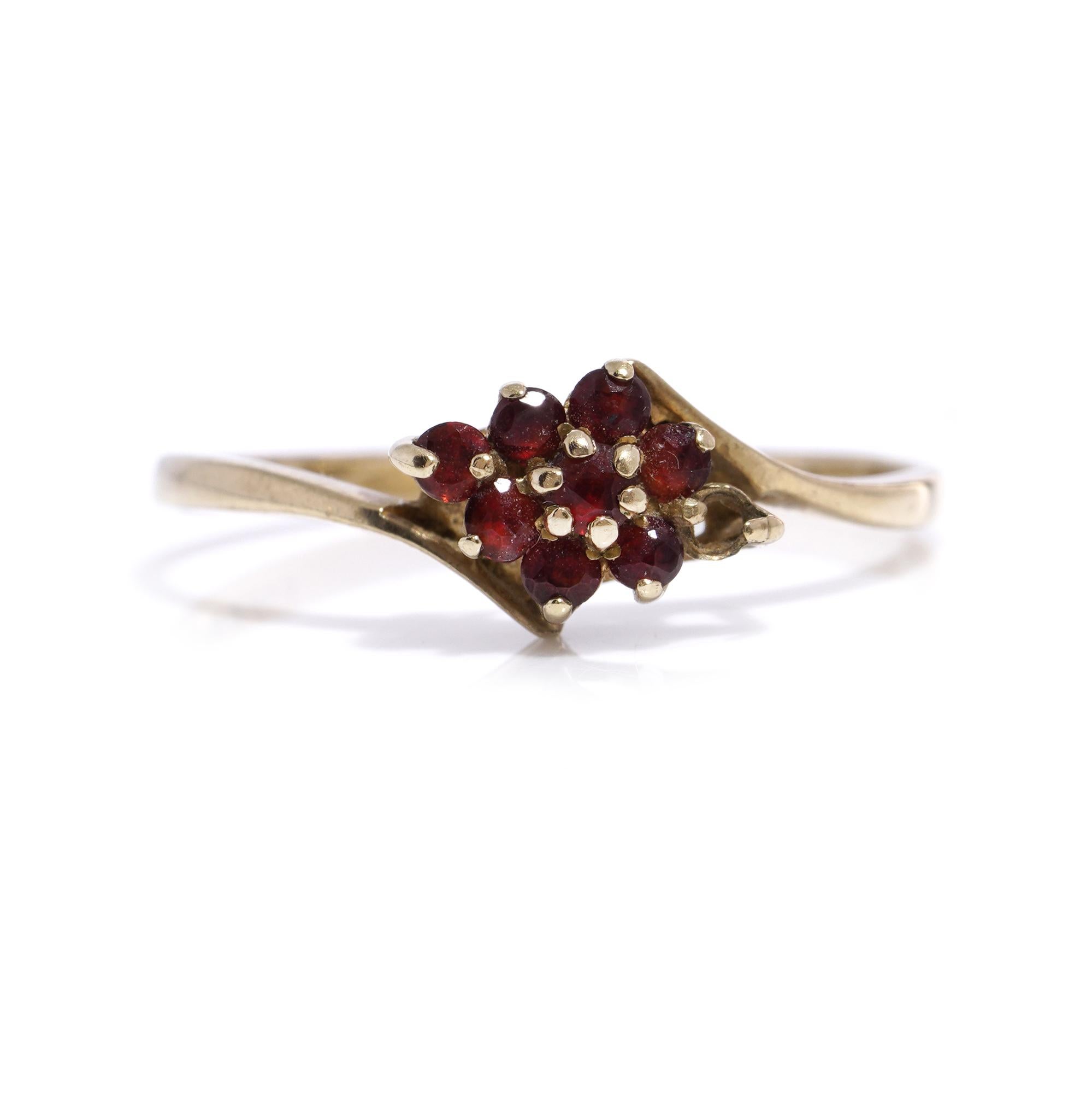 Vintage 9kt yellow gold garnet cluster ring.
Made in England, London, 1984
Fully hallmarked.

Dimensions -
Finger Size (UK) = O 1/2 (EU) = 56.5 (US) = 7.75
Weight: 1.00 gram

Garnets -
Cut: Round faceted
Quantity of stones: 7
Carat weight: 0.21