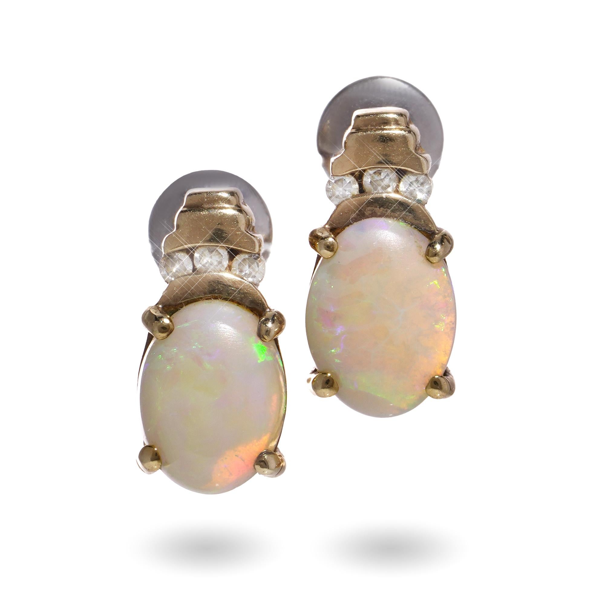 Vintage 9kt yellow gold pair of diamond and opal studs.
Made in 1988.

Dimensions -
Length: 1.3 cm x 0.6 cm
Weight: 3.00 grams

Diamonds -
Cut: Round brilliant
Quantity of stones: 6
Carat weight: 0.06 carats in total
Clarity: SI1
Colour: G - H

Each