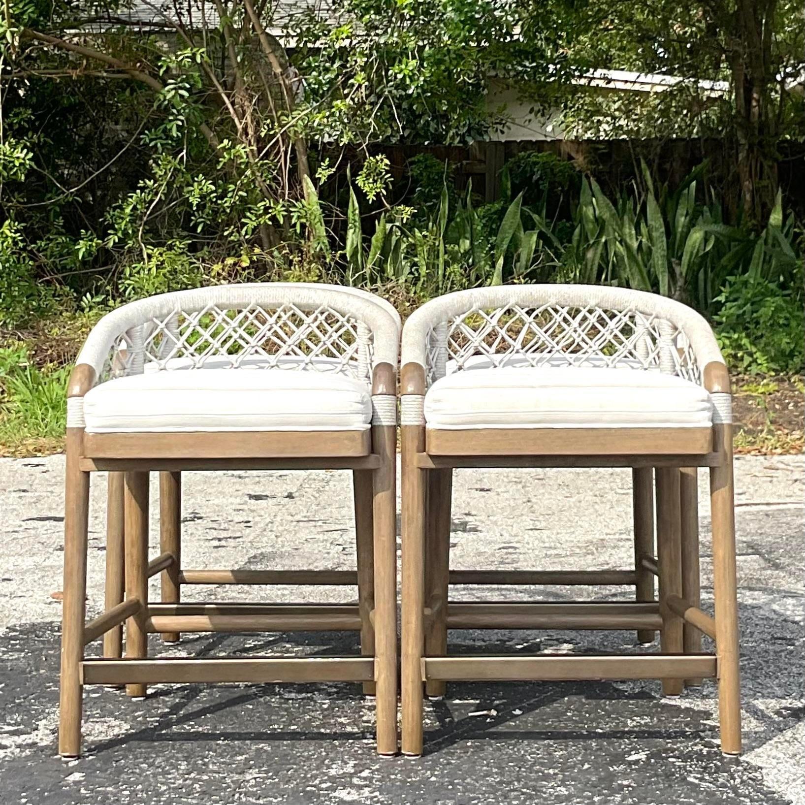 Elevate your coastal decor with this set of 4 vintage Palecek 'Otis' rope counter stools. Crafted with artisanal flair and sturdy construction, these stools embody the essence of seaside living. Perfect for adding a touch of relaxed elegance to your