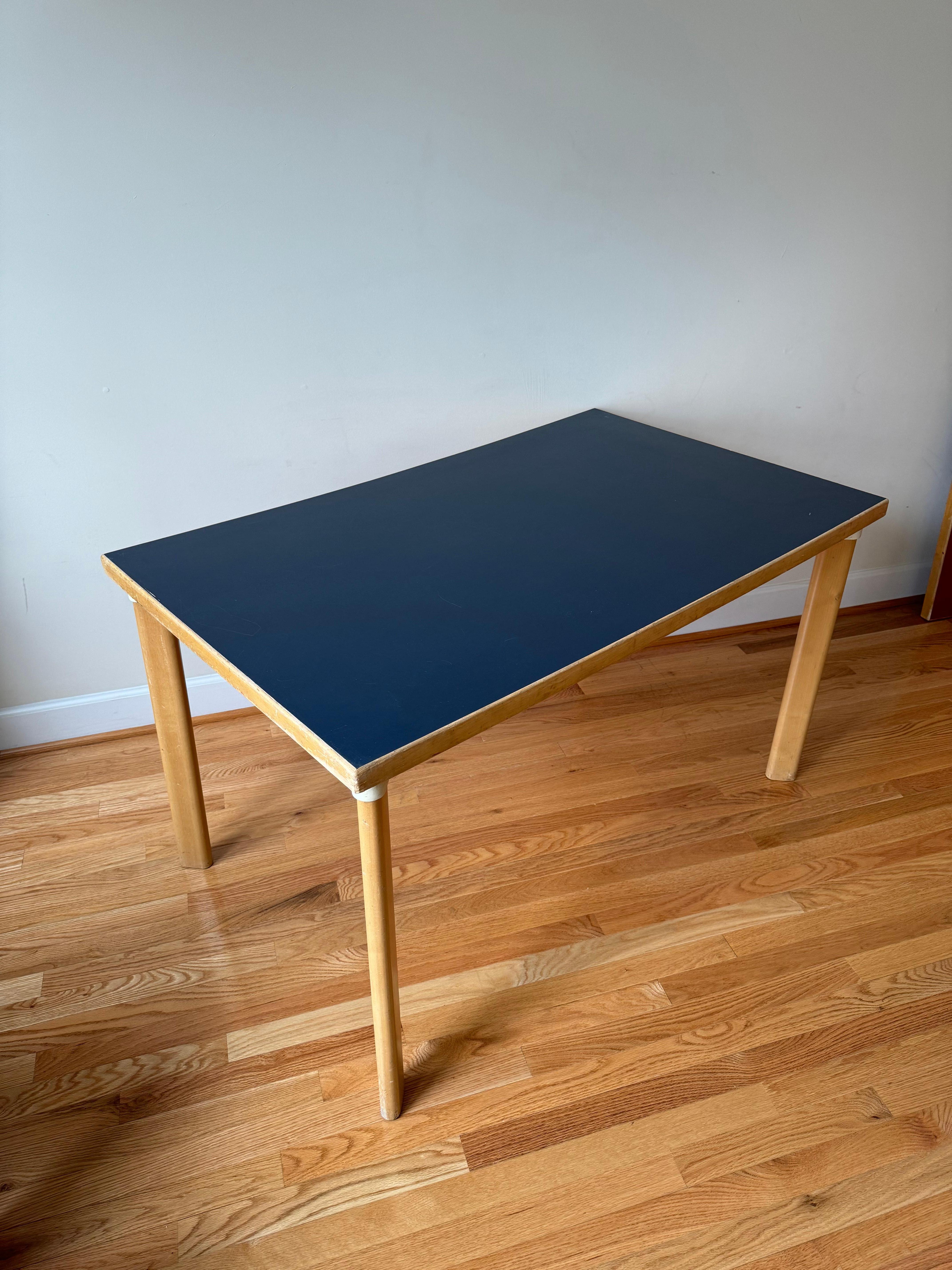 H-legged Table (Table 81B)  with blue linoleum top
(Blue linoleum top is no longer in production)

The last of Alvar Aalto’s inventions to be adopted by the furniture industry was the sleeve or H-leg. The sleeves were in metal and screwed to the