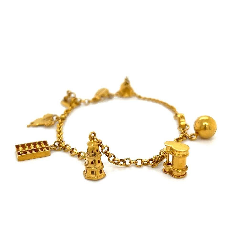 Simply Beautiful! Vintage Multi Charm 22K Gold Multi Charm Bracelet, showcasing an Abacus, Bell, Cello, Iron and Rooster. Approx. 7” Long. Comes with a Certificate of Authenticity. Excellent unworn Condition. Chic and Fun to Wear! Sure to be