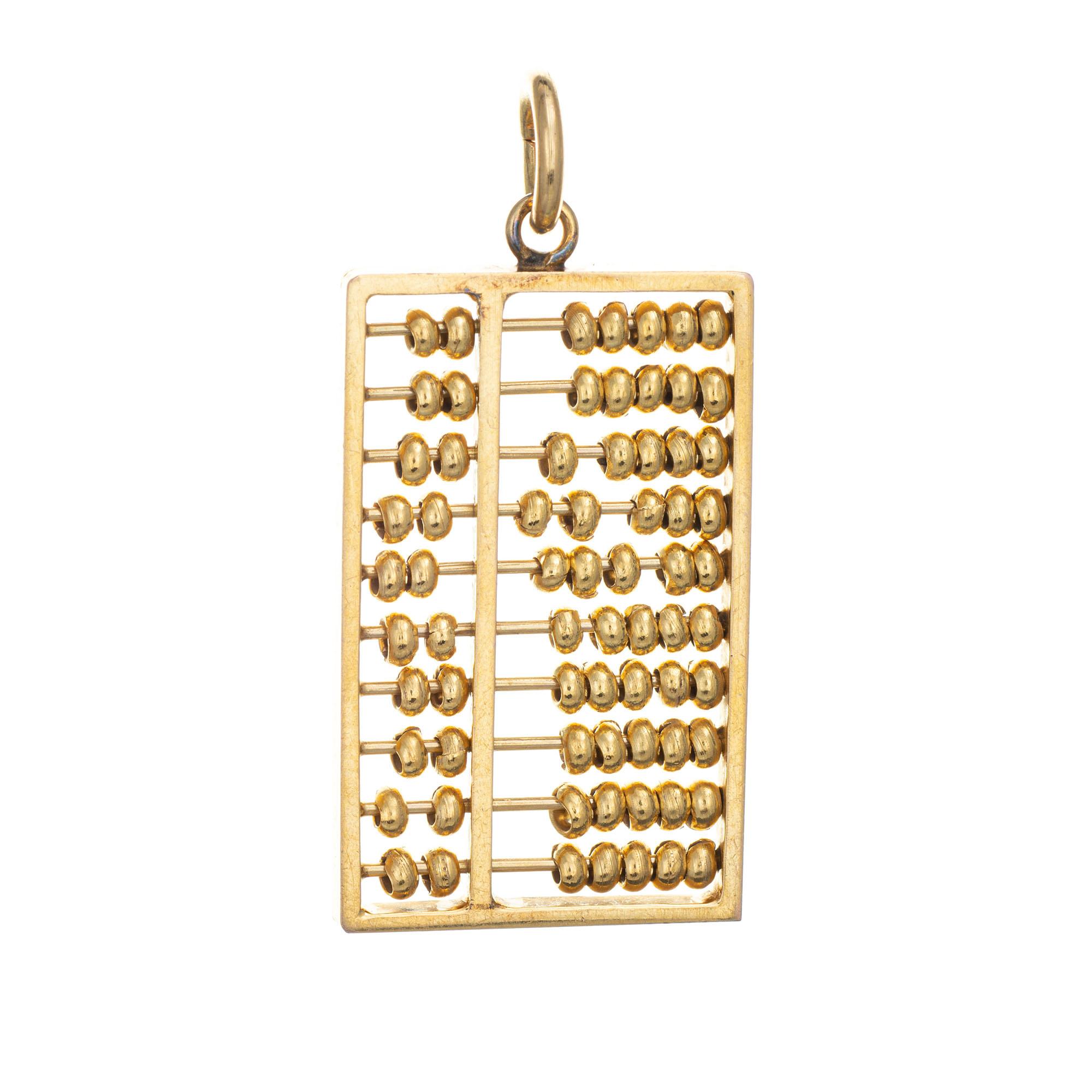 Finely detailed vintage Abacus charm crafted in 14k yellow gold.  

The large abacus features movable beads inside the frame. The charm has a heavy feel and weighs in at 17.1 grams. The piece can be worn as a charm on a bracelet or as a