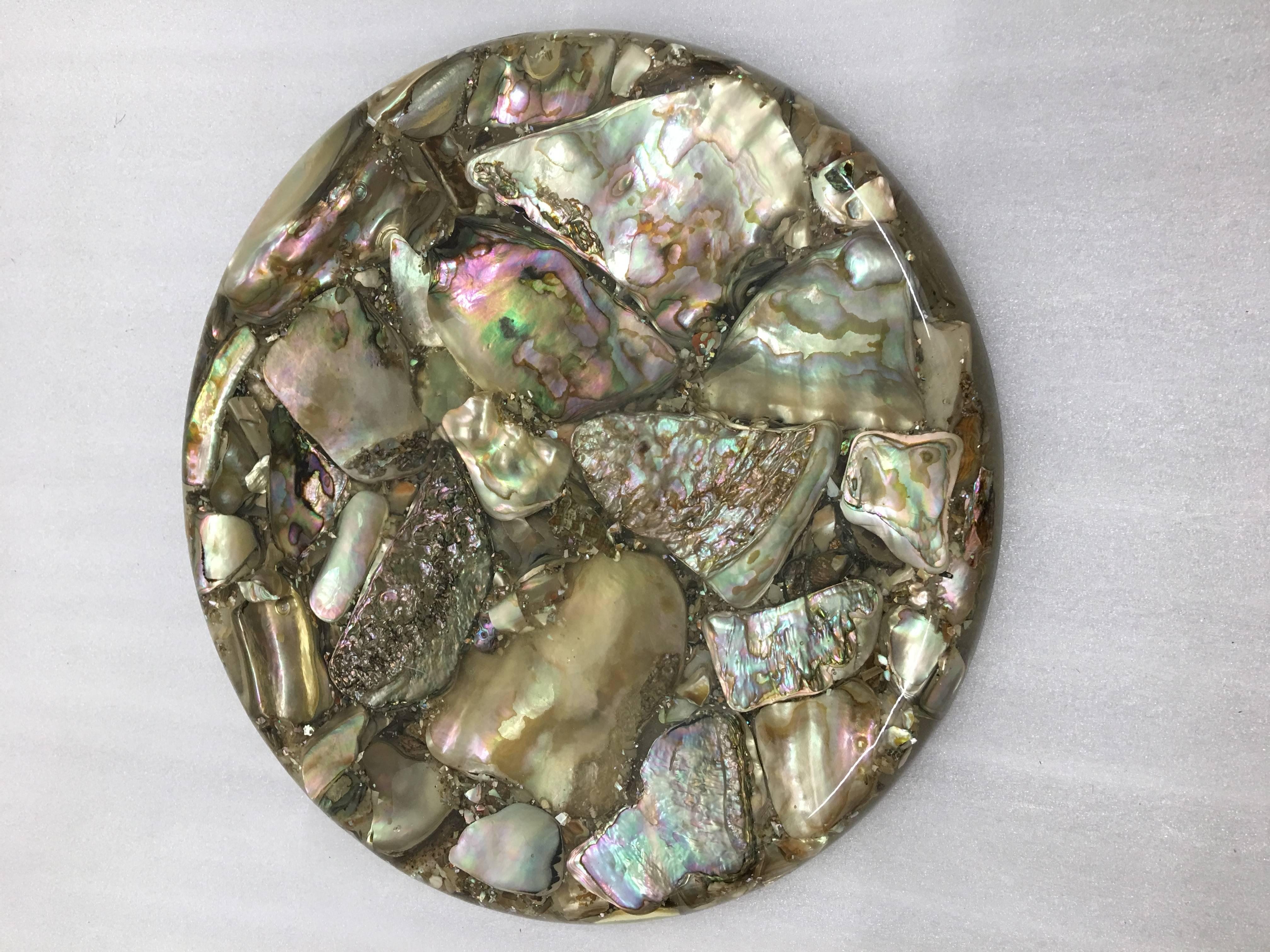 A small and fanciful abalone shell trivet or serving piece from Catalina Island.