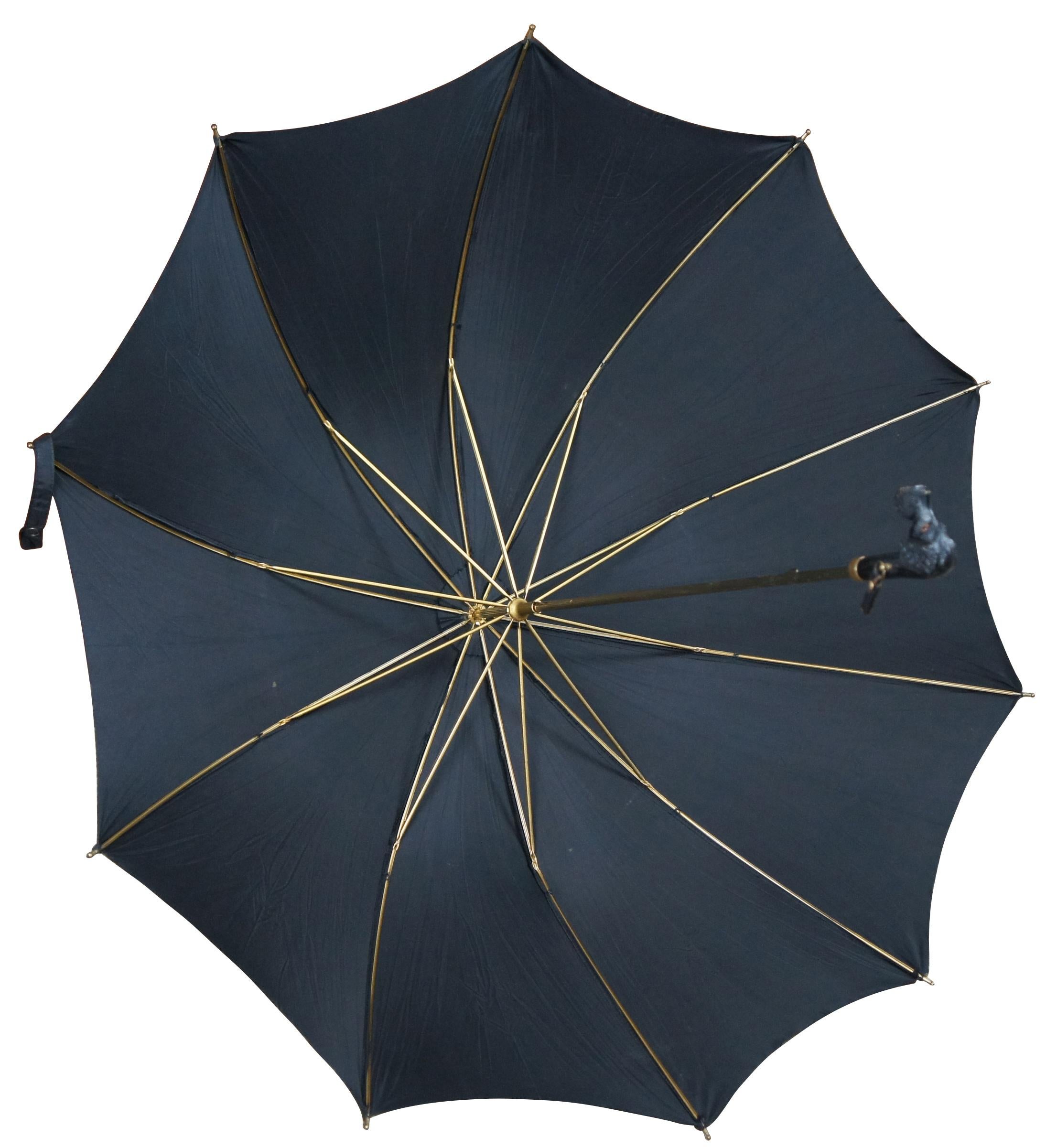 Rare vintage black umbrella with Scottish Terrier dog head handle and brass tip; marked ABC at the dog’s neck.

Folded - 2.5” x 1.25” x 25” / Diameter Open – 32.75” (Width x Depth x Length/Diameter).