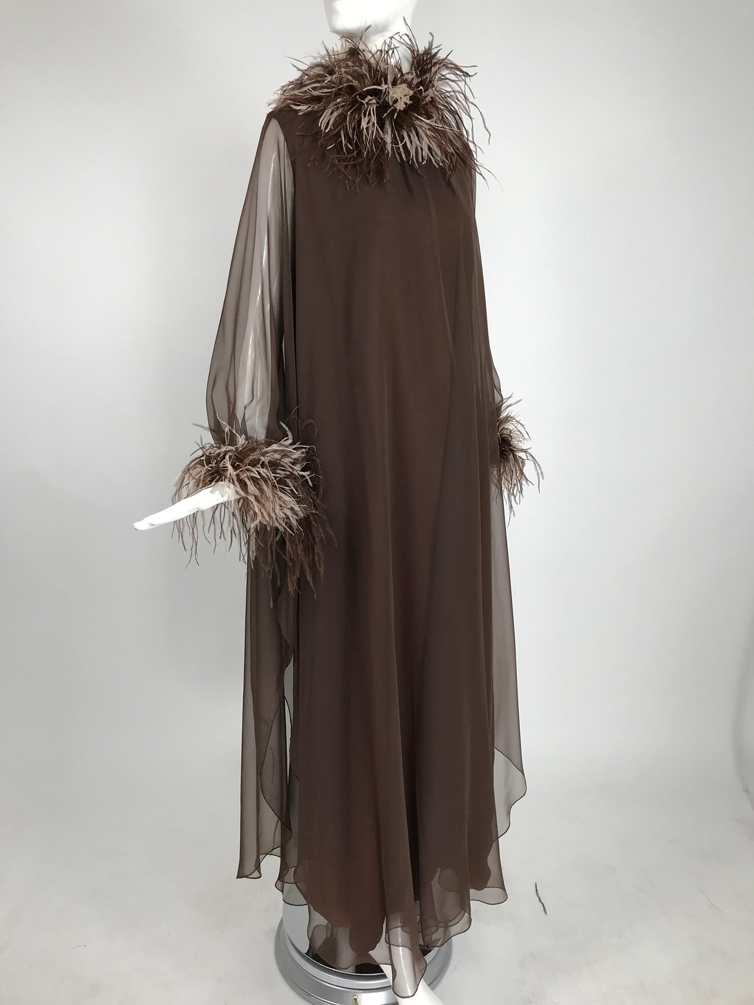 Abe Schrader chocolate brown chiffon and ostrich feather trim caftan from the 1970s.  This dramatic caftan is perfect for at home entertaining. It fits an approximate size medium or a smaller large. The sheer chiffon caftan has bat wing sleeves, the