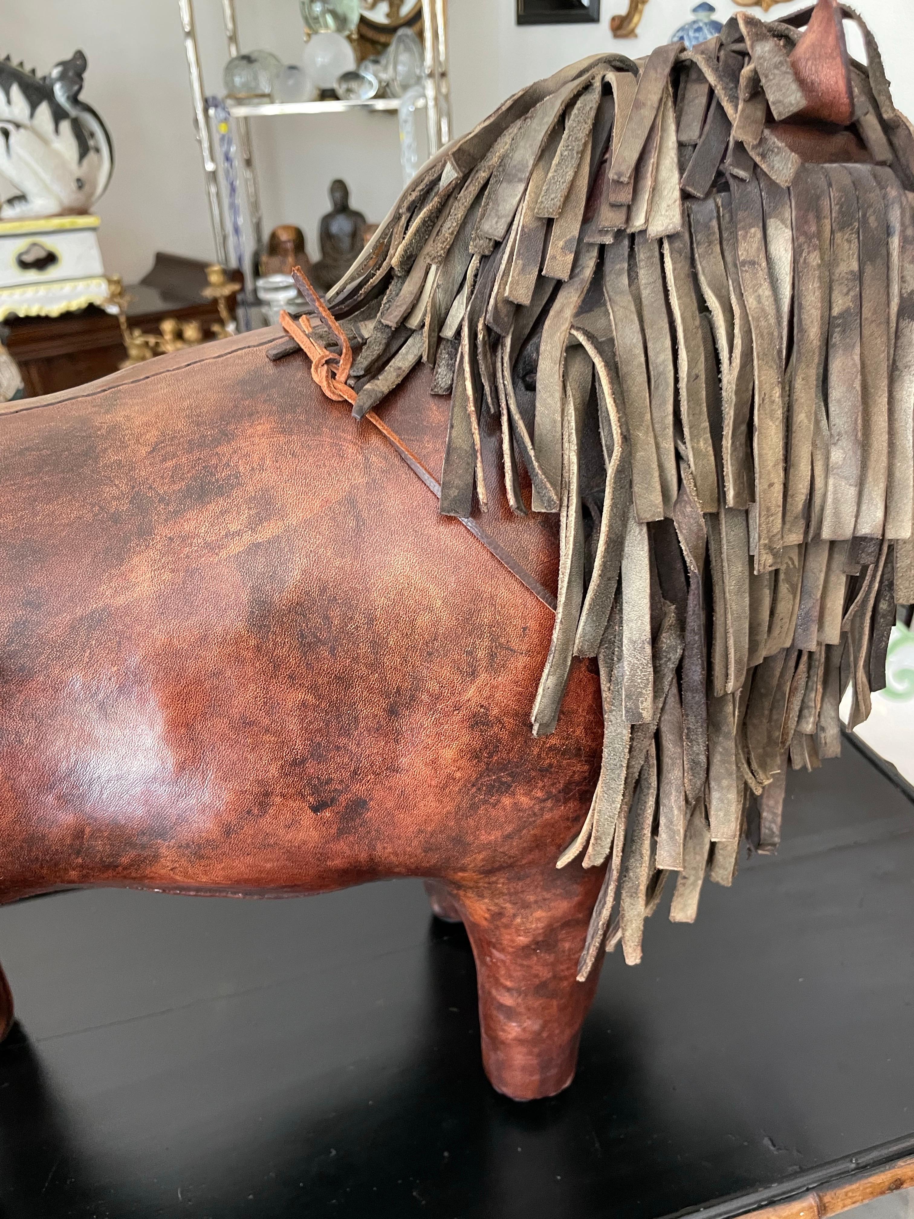 Iconic vintage and rare handmade leather lion footstool by Dimitri Omersa for Abercrombie & Fitch. In wonderful like new condition. A great example of the maker's work. All hand stitched with great attention to detail.