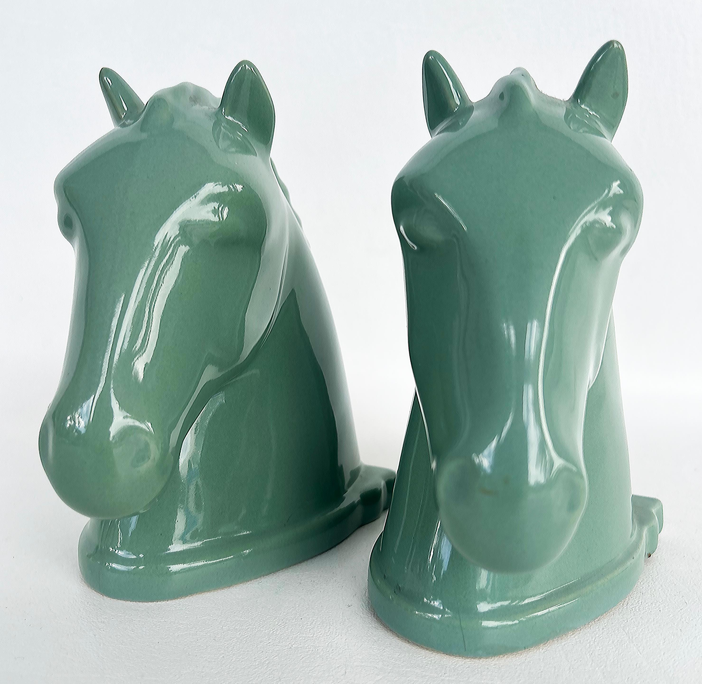 Vintage Abingdon USA Ceramic Horse Head Bookends with Labels, Pair 

Offered for sale is a pair of substantial early Mid-Century ceramic horse bookends from Abingdon Pottery. The horses are glazed in green which is an uncommon color for Abingdon. 