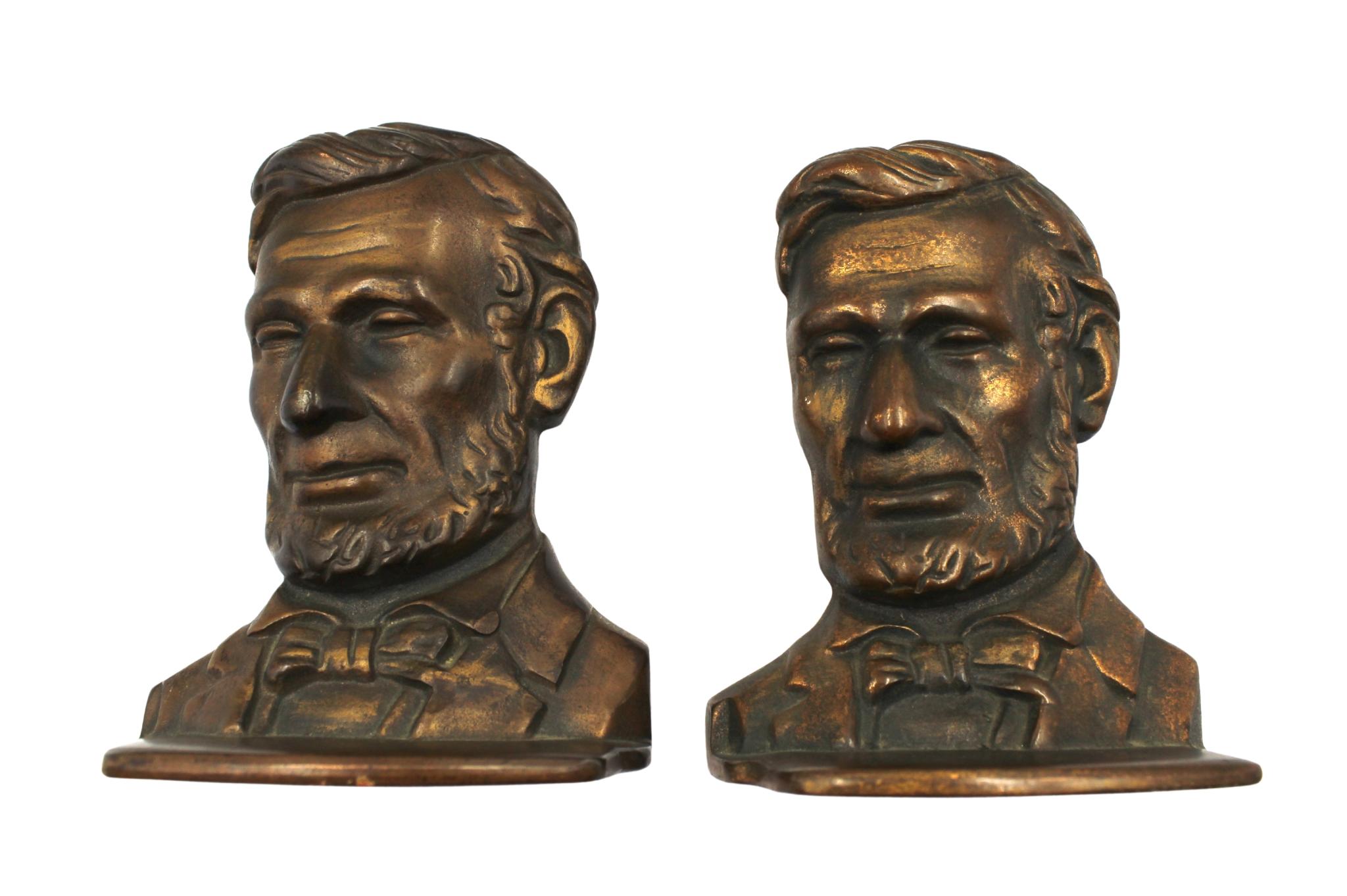 Offered is a pair of vintage Abraham Lincoln bust bookends. The pair feature the likeness of Abraham Lincoln with detailed facial features and formal attire. 

The Lincoln bust is modeled after the 1887 full-length standing bronze by Augustus