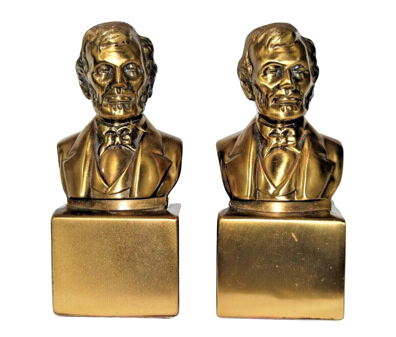 This is a pair of vintage Abraham Lincoln bust bookends. These bookends are made of brass and were produced by PM Craftsman in the U.S. On the base is a PM Craftsman label. The bookends depict President Abraham Lincoln, from head to shoulders, atop