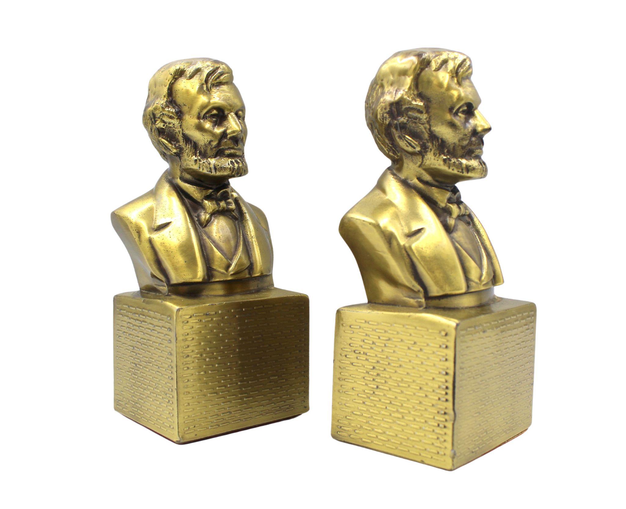 This is a pair of vintage Abraham Lincoln bust bookends. These bookends are made of brass and were produced by PM Craftsman in the U.S. On the base is a PM Craftsman label. The bookends depict President Abraham Lincoln, from head to shoulders, atop