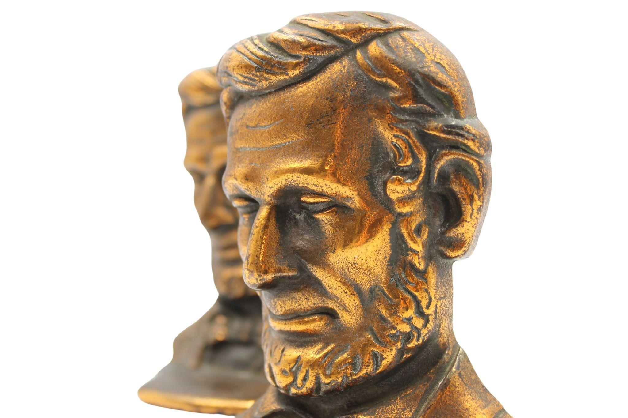 Offered is a pair of vintage Abraham Lincoln bust bookends. The pair feature the likeness of Abraham Lincoln with detailed facial features and formal attire. 

The Lincoln bust is modeled after the 1887 full-length standing bronze by Augustus