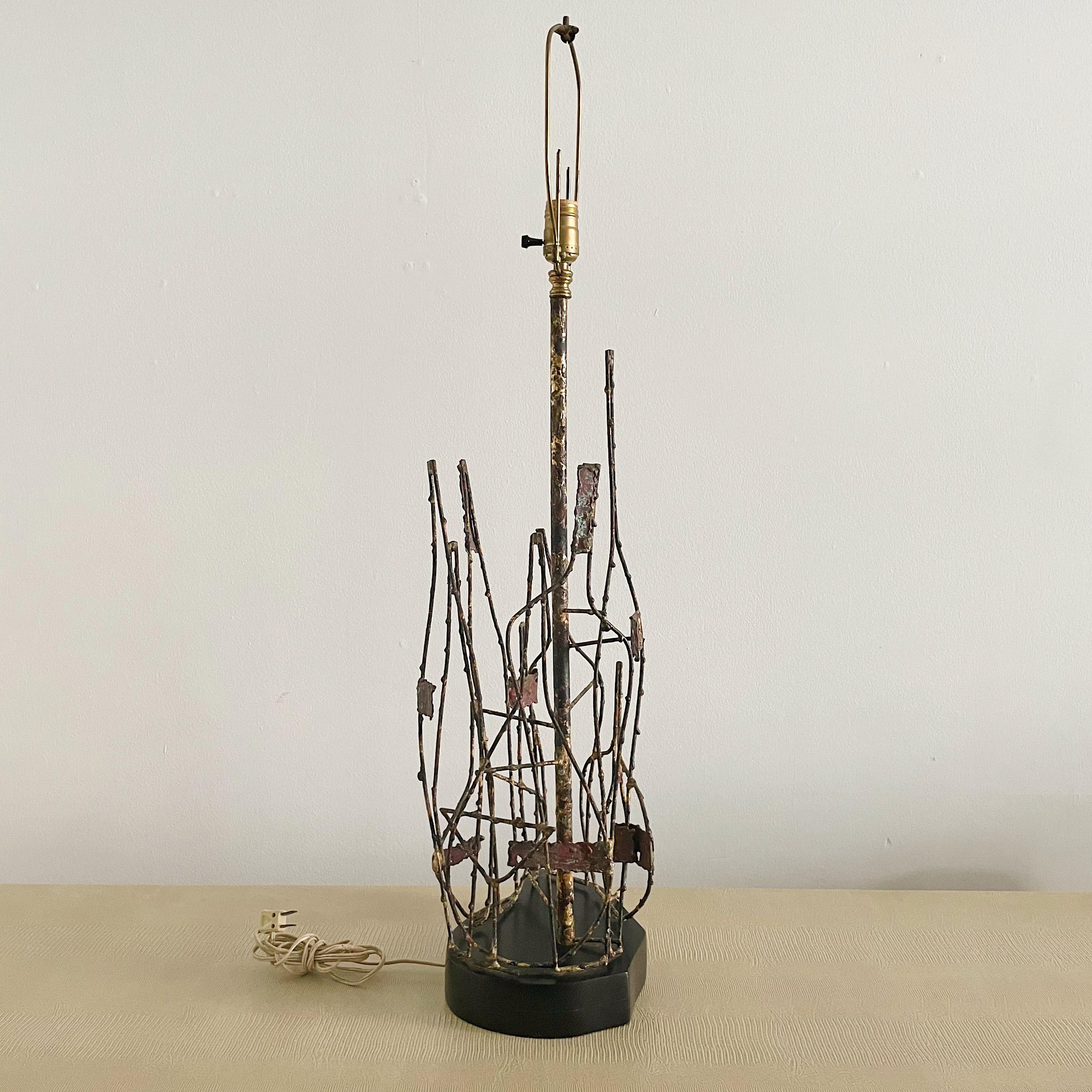 Available for purchase is a rare #347 lamp from Marcello Fantoni, which is signed and originally from Firenze, Italy. This lamp is an early example of Fantoni's work, characterized by a Brutalist painted metal body and a signature tag on a