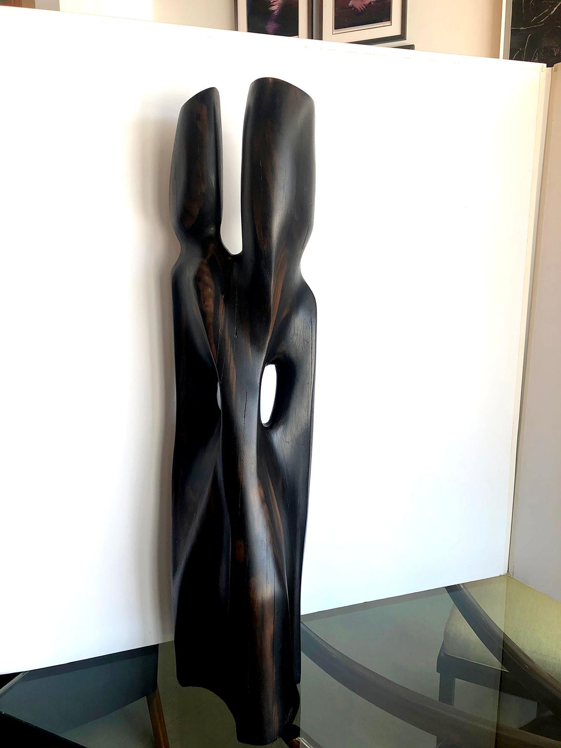 Vintage rosewood sculpture by Raul Varnerin. Abstract figural form carved out of heavy rosewood, mostly black in color with some slightly warmer undertones. (see close up picture for grain).