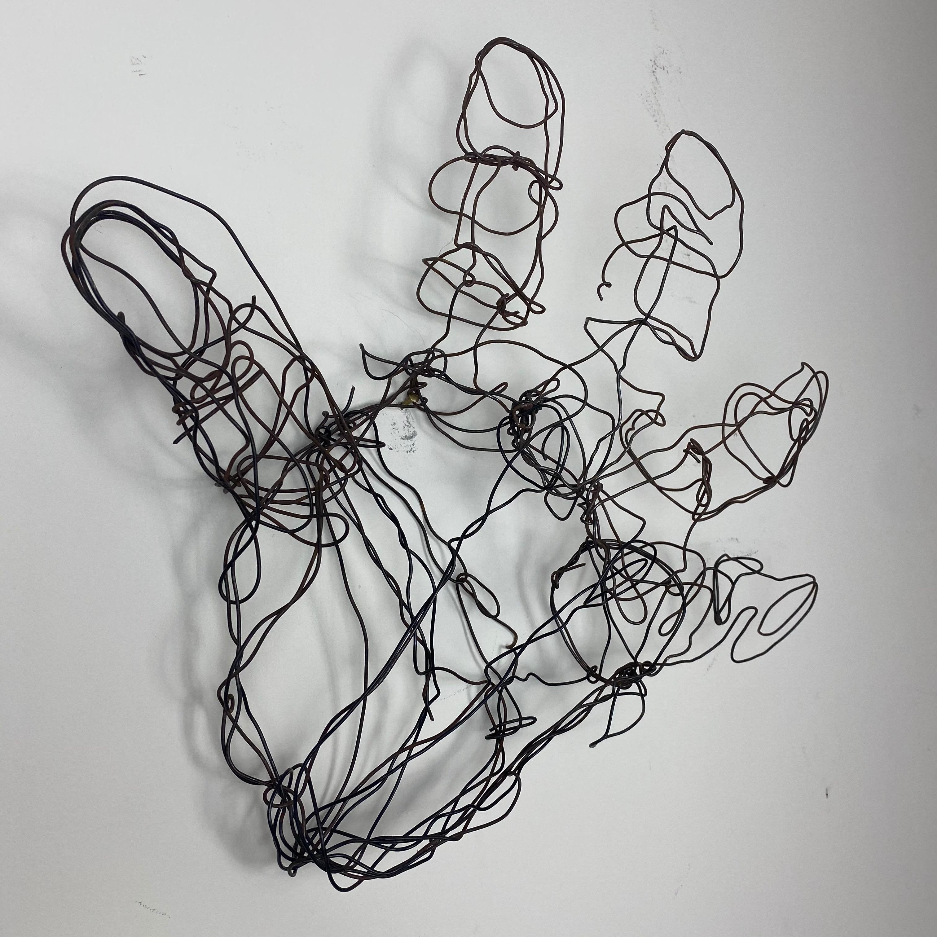 Formed wire abstract wire hand sculpture. A light patina has formed on the steel wire giving this abstract sculpture and warm appearance. Can be wall-mounted or simply rest on a surface.