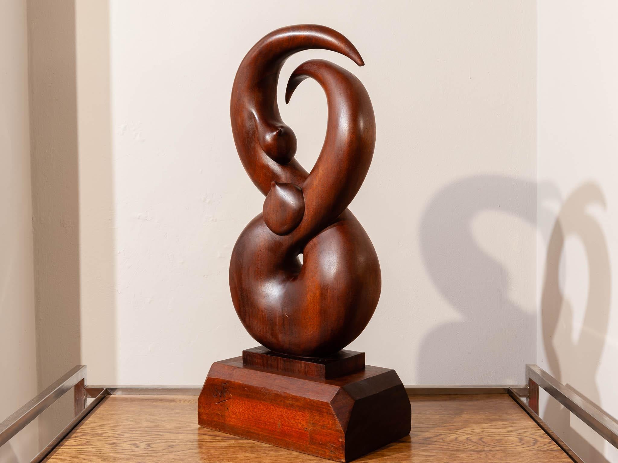 An unusual vintage wooden figure of eight sculpture. The artists initials, JyF, are engraved into the large wooden plinth base. Two unusual formed breasts are sculpted into the wood. One in the middle and another on the left hand side on the upper