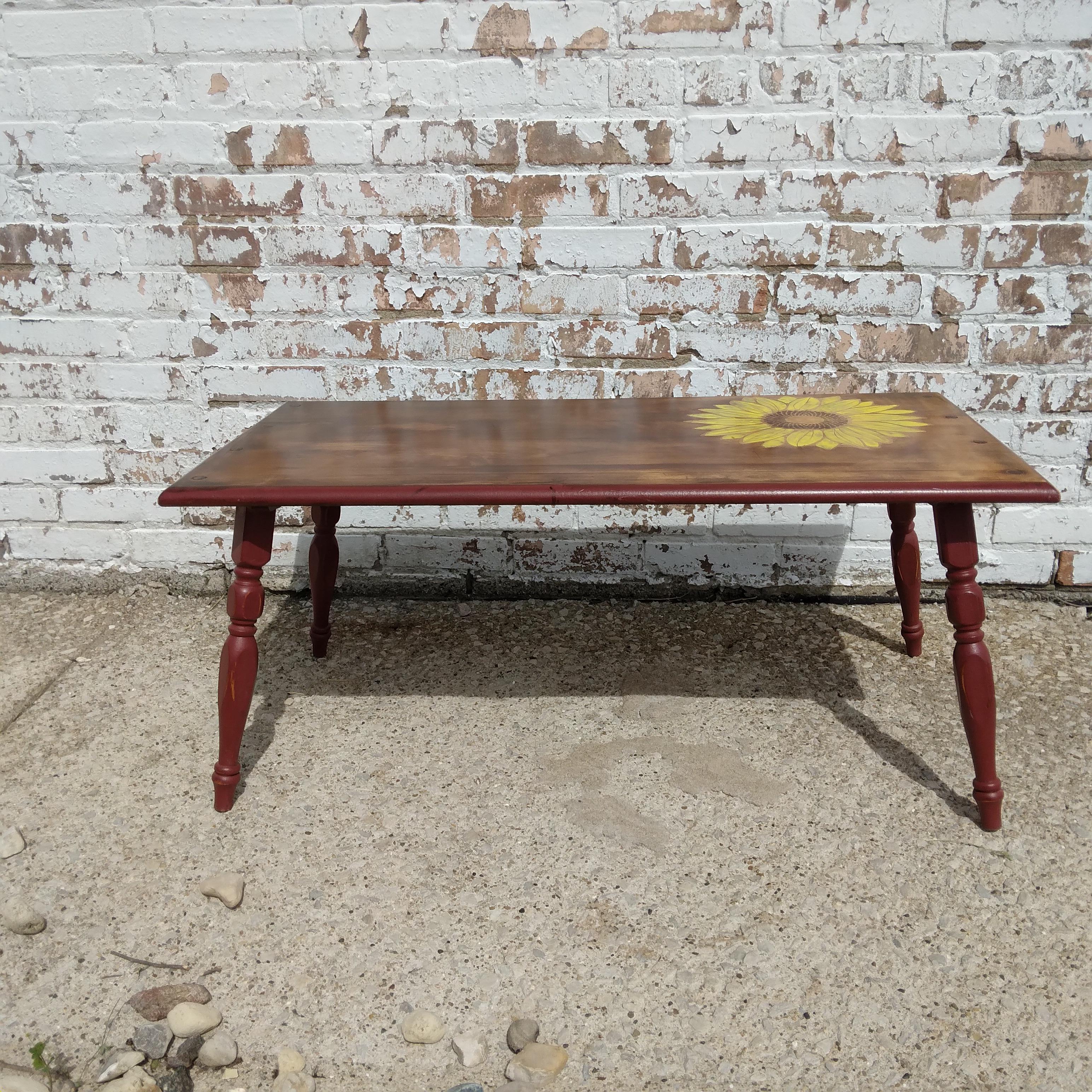 Emblazoned with cheerful, yellow petals, this low-set table is the perfect combination of bright and rich. We love the complex colors of her stained top paired with a dusty rose hued base. Her vintage turned legs are pretty and delicate. Perfect for