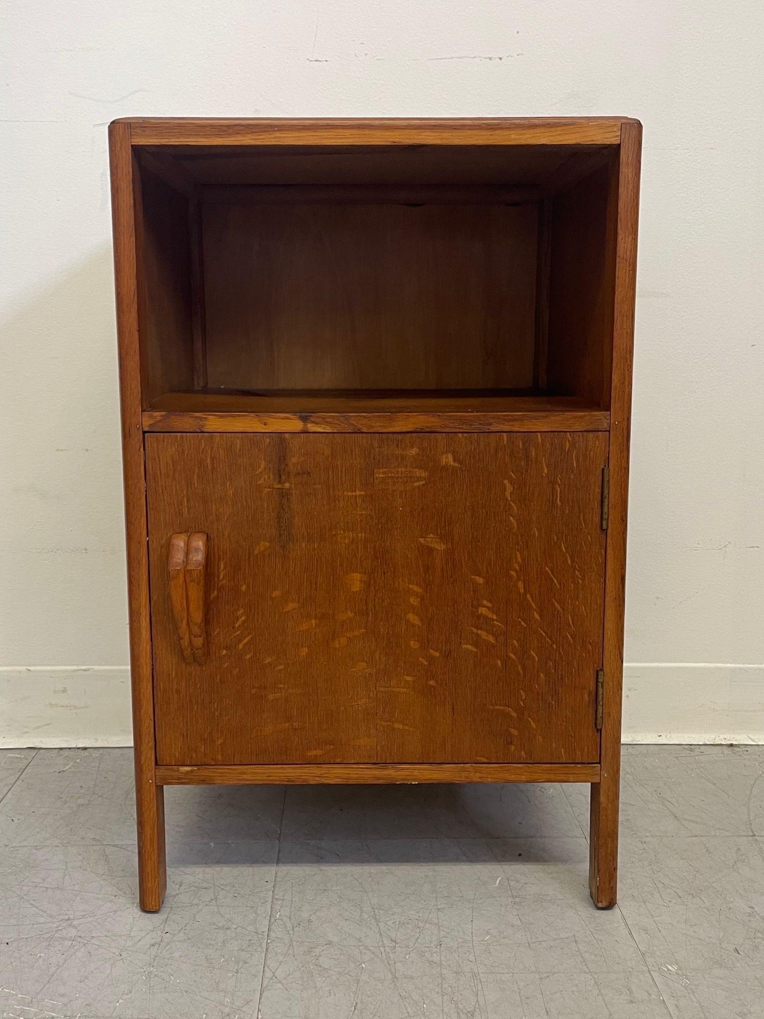 Possibly Tiger Oak based on the unique wood grain. Handle has an interesting carved wood Shape. Open shelf above Cabinet. English Mid Century style. Vintage Condition Consistent with Age as Pictured.

Dimensions. 16 W ; 13 D ; 26 H