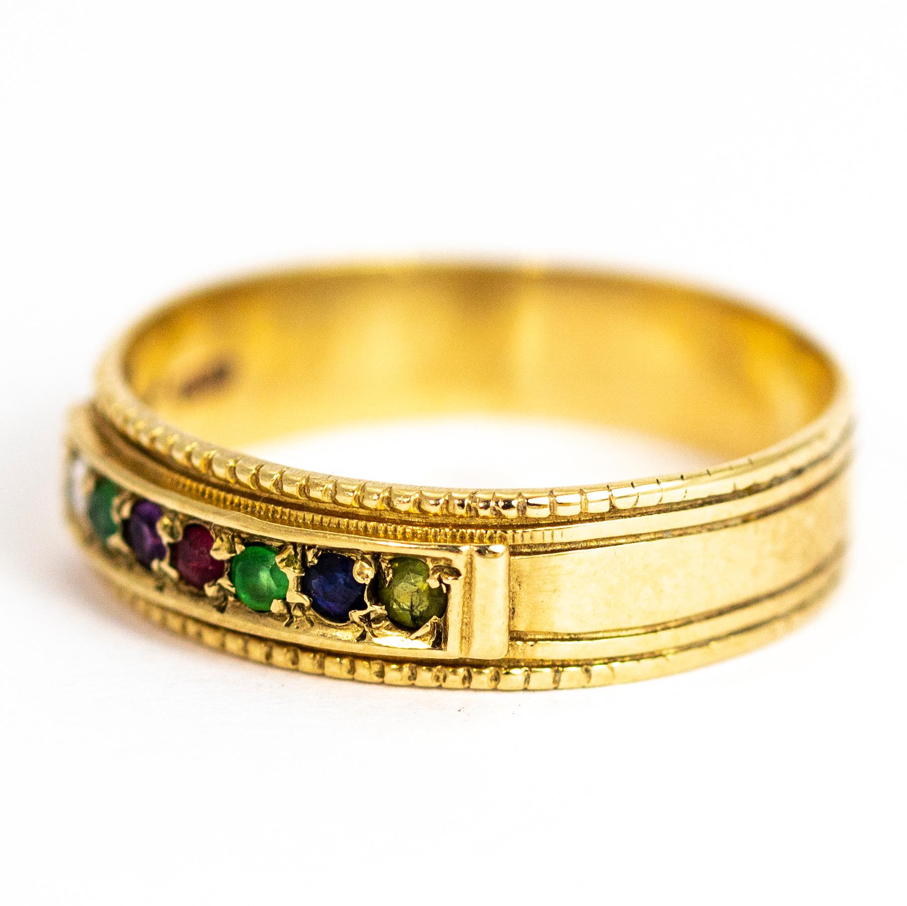 This lovely band has seven stone set within it which spell the word 'Dearest'. This is does this by using Diamond, Emerald, Amethyst, Ruby, Emerald, Sapphire and Tourmaline. The wide band is modelled in 9ct gold and has line detail engraved all the