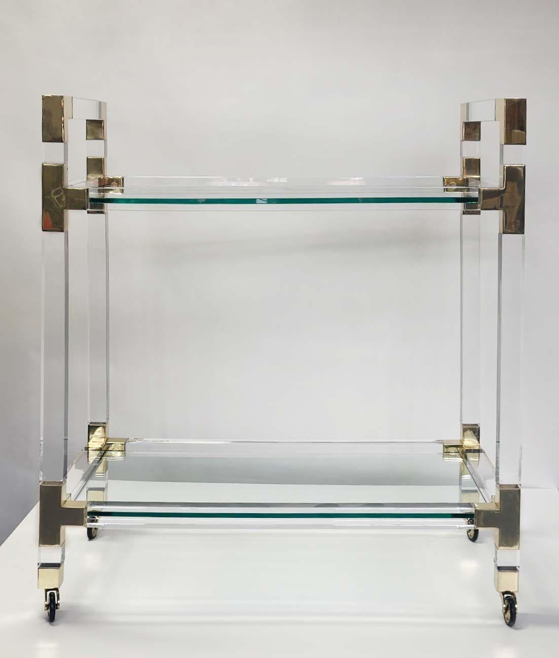 Vintage acrylic, brass and glass bar cart by Charles Hollis Jones. Made in USA, circa 1970s.
Dimensions:
36.5