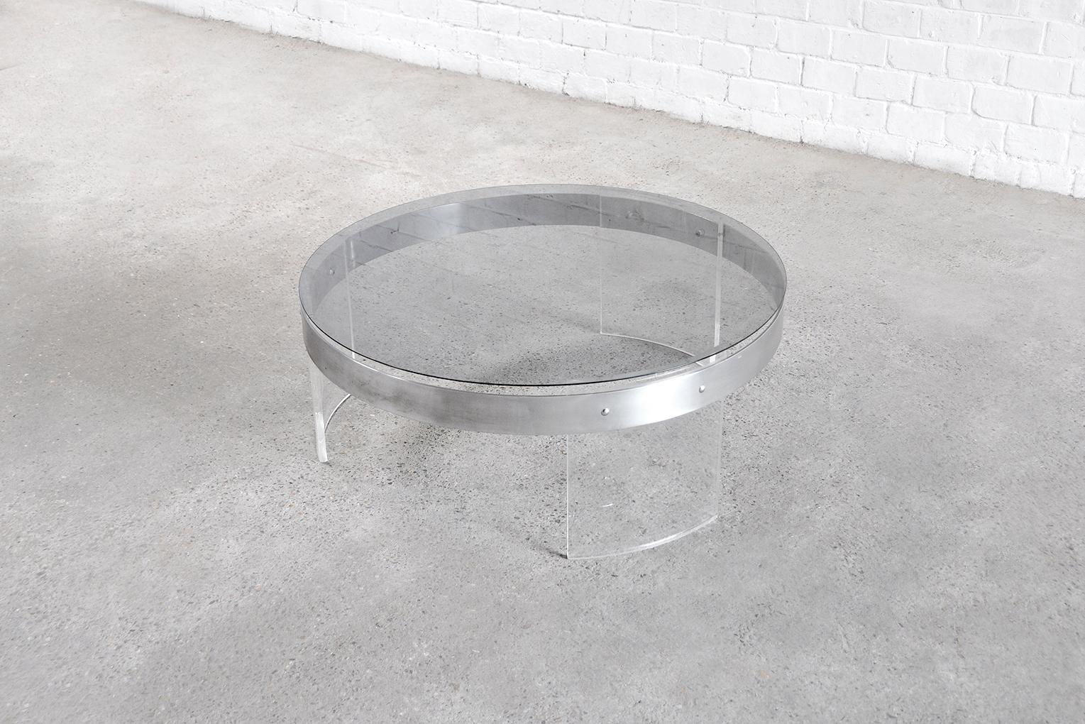 Beautiful round vintage coffee table designed in France in the 70s. A piece of high manufacturing quality with a stunning mixture of materials. Thanks to the use of acrylic, the design is minimalist which results in a refined piece that will bring a