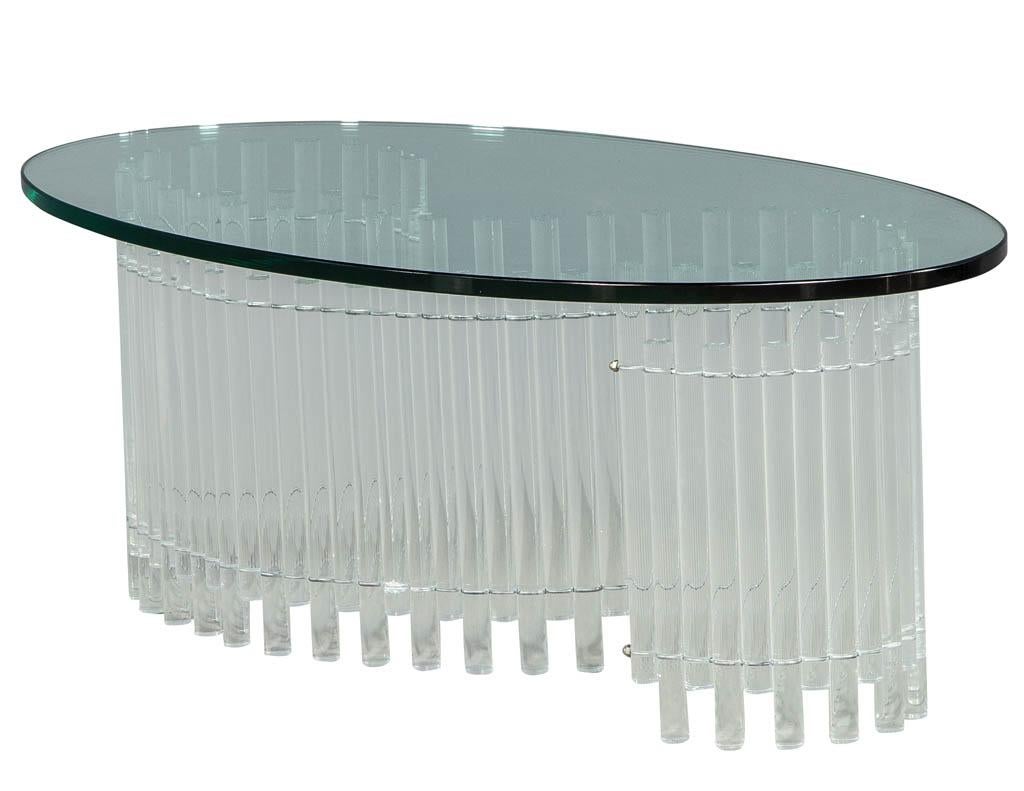 Unique vintage coffee table with a serpentine S-shaped base consisting of acrylic tubes joined in a tambour style configuration. Finished with a generous oval top. Completely original, this piece has extremely minor signs of use consistent with its