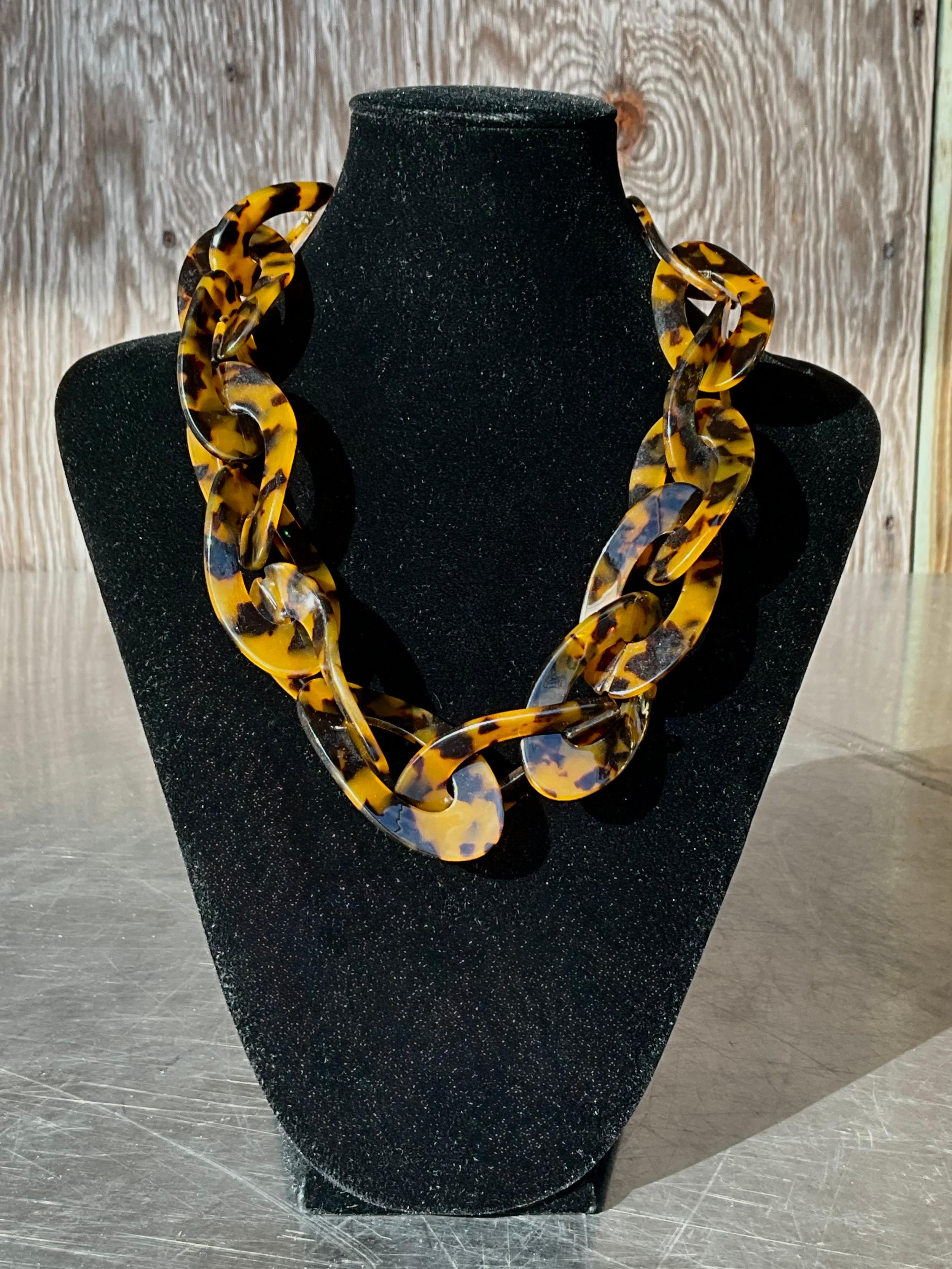 A Vintage Acrylic Tortoise Necklace is a chic and timeless piece of jewelry that blends vintage appeal with the unique characteristics of acrylic material. 

As a vintage item, this necklace likely dates back several decades, with many such pieces