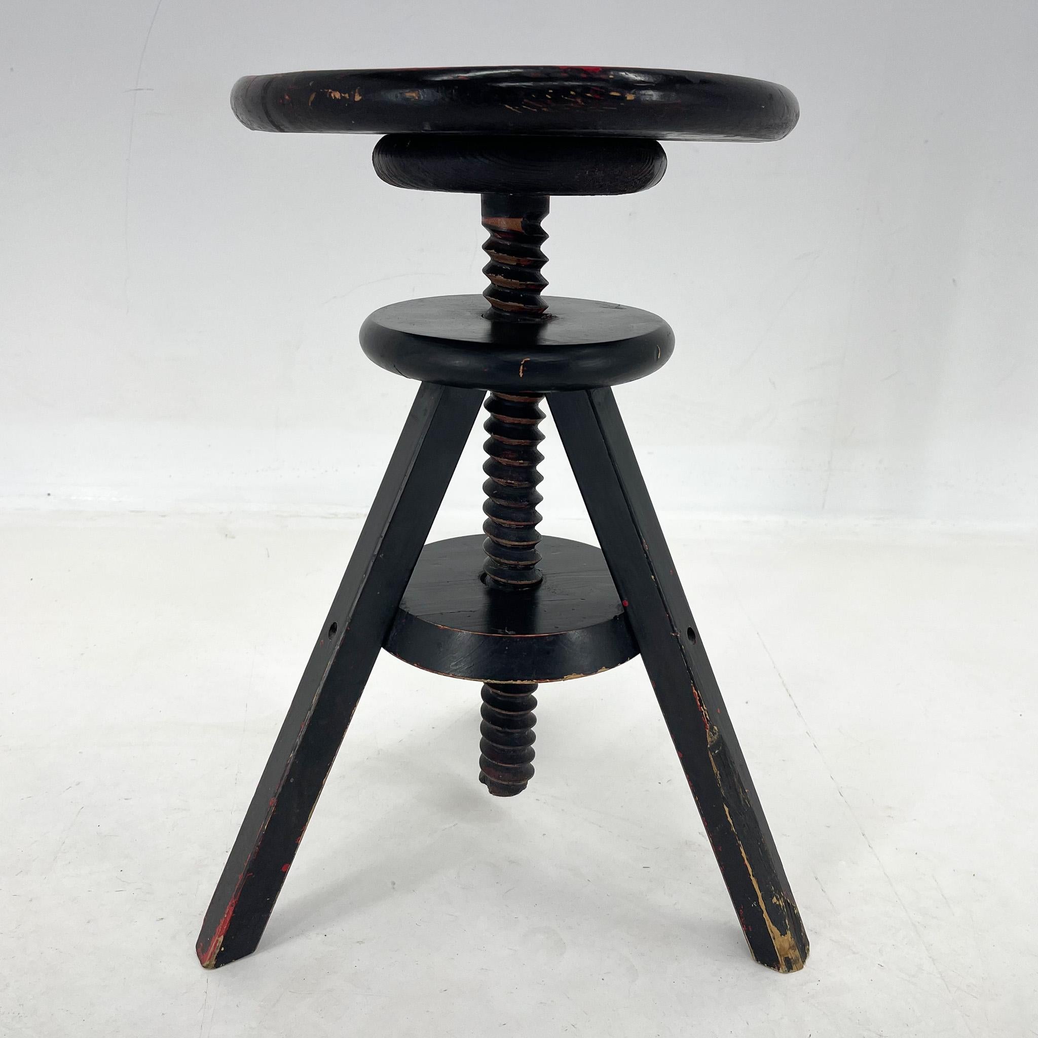 Stable whole wooden vintage stool with original patina. The hight is adjustable. The upper part has a diameter of 30 cm. The widest part at the ground is 39 cm. 61 cm is the maximum hight.