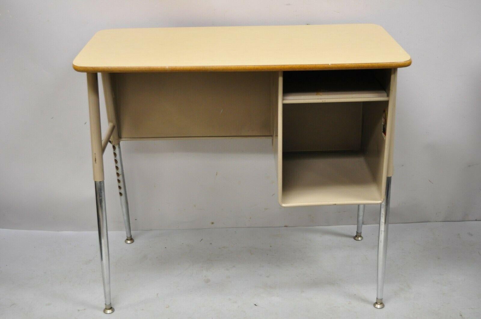 Vintage Adjustable Height Metal School Desk With Laminate Top. Item features a wood grain laminate top, adjustable height metal base, very nice vintage item, sleek sculptural form. Mid to Late 20th Century. Measurements: 29