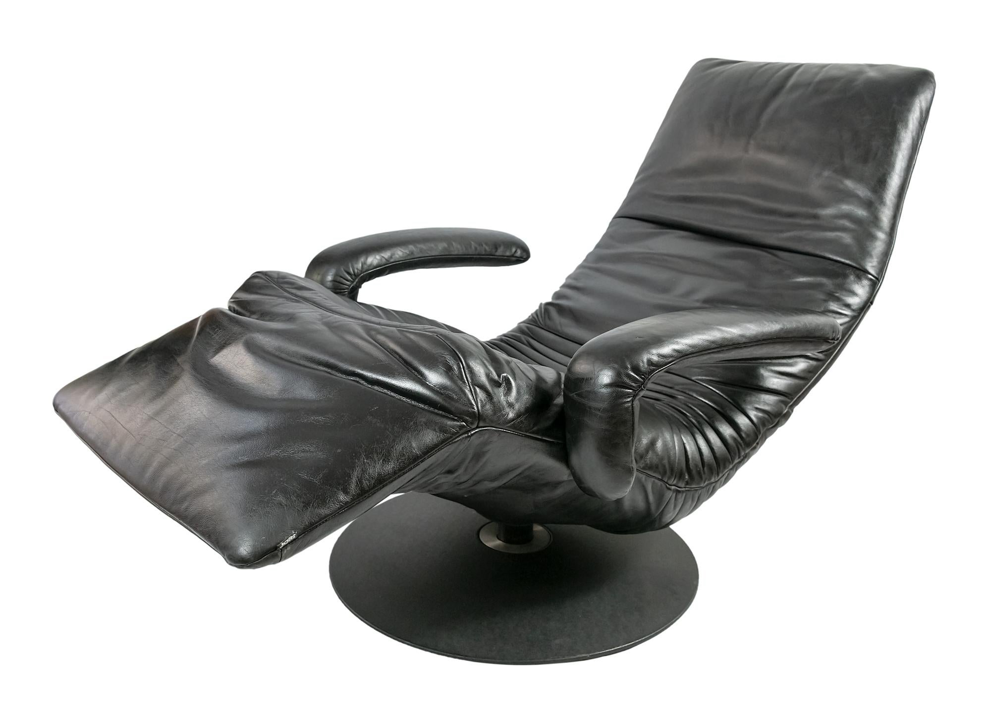 Vintage adjustable reclining lounge armchair in black leather and heavy metal base for absolute seating and lying comfort.
This model Yoga is manufactured circa 2000s by Belgian Company JORI.
The armchair is adjustable from seating to horizontal